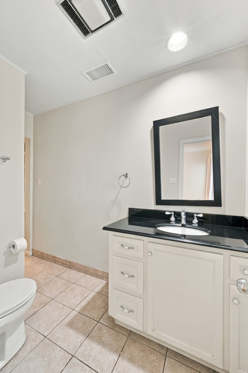Secondary bathroom has a shower with built in storage across from shower