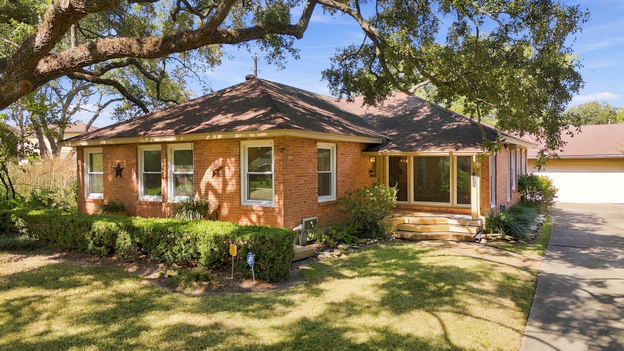 This home has two seating areas in front. One is tucked behind the boxwoods along the front of the house and the other is a welcoming covered front porch