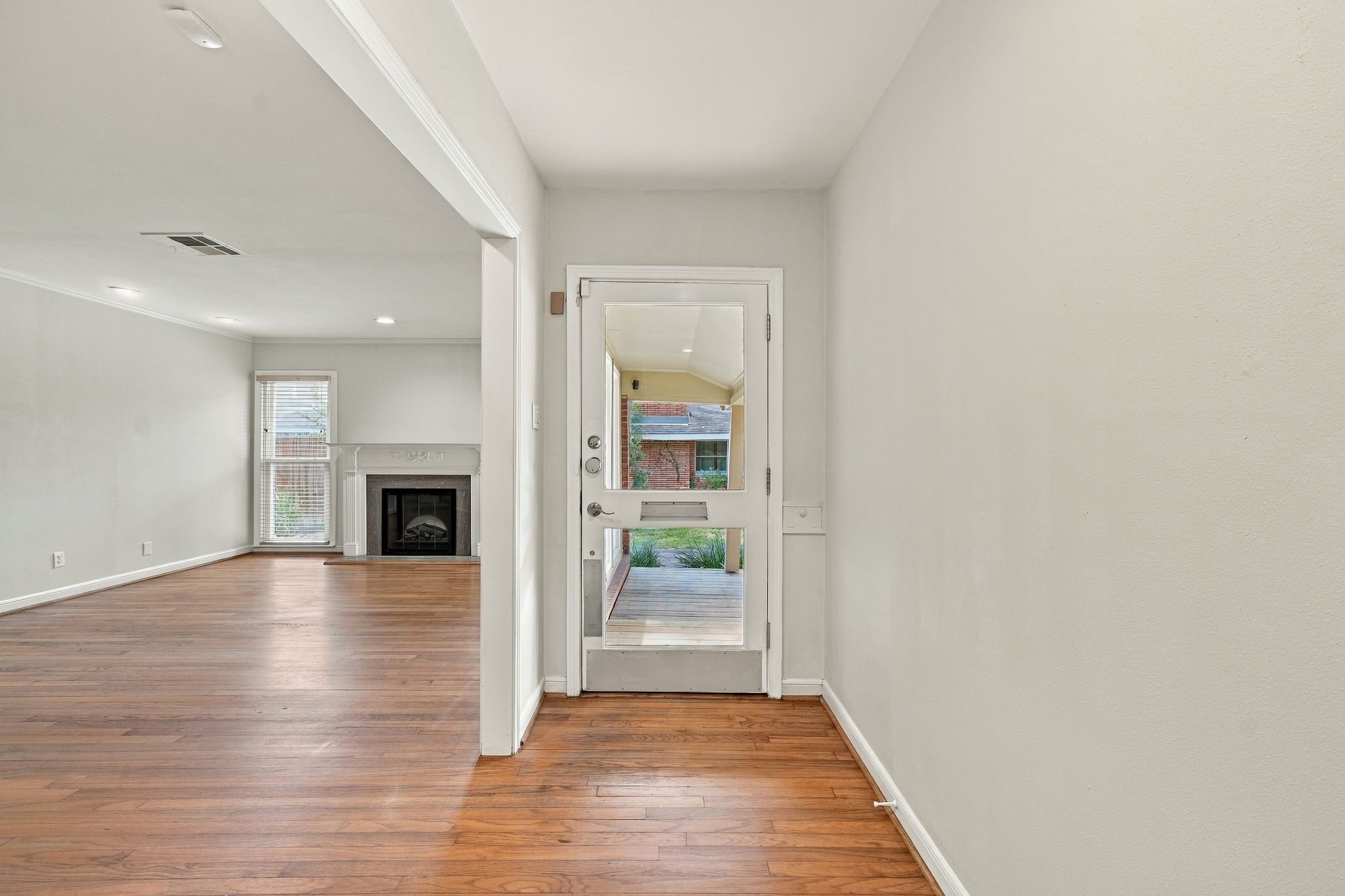 View of light filled foyer and spacious living room View of light filled foyer and spacious living room
