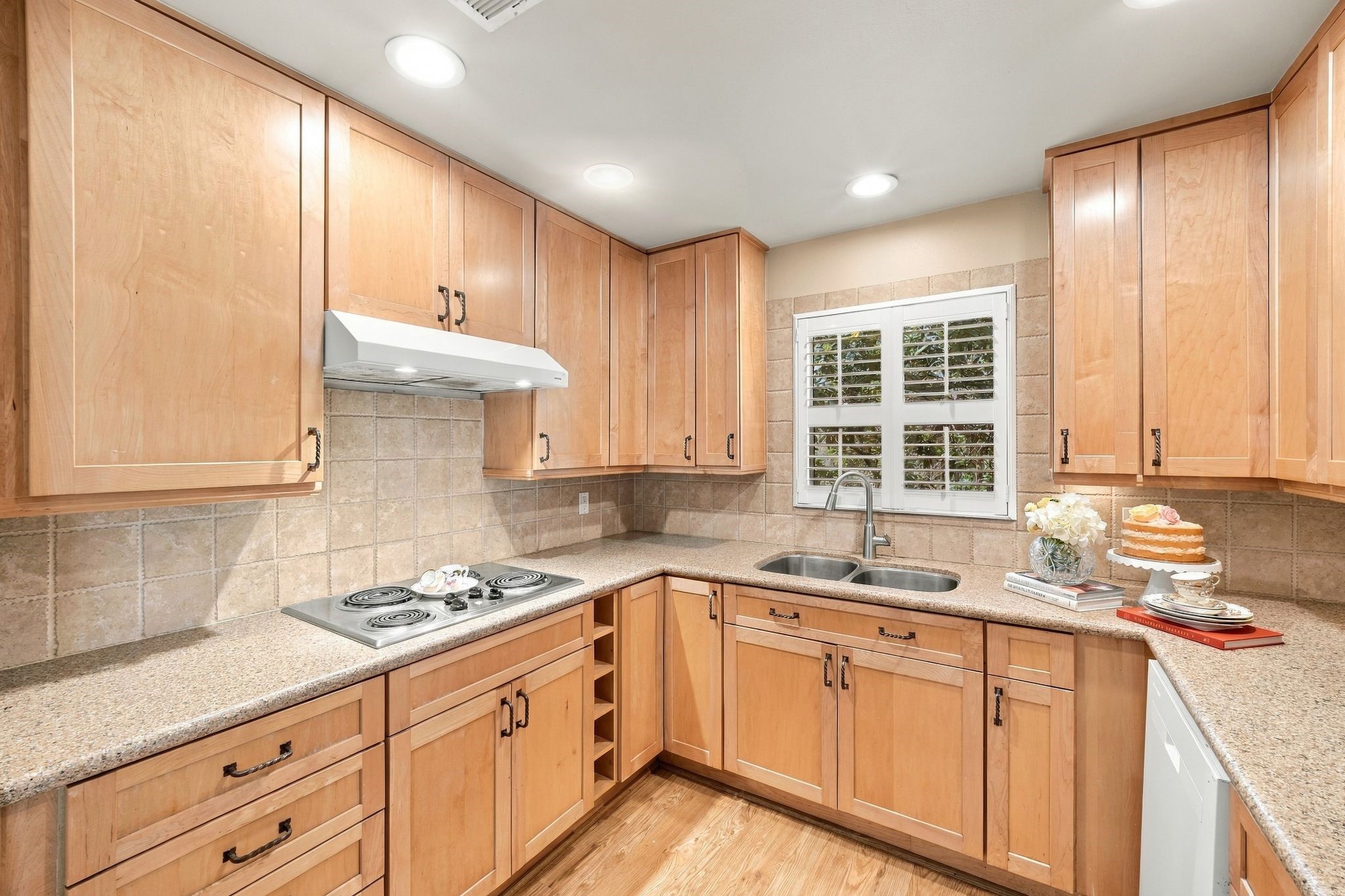 Functional and inviting kitchen with plenty of storage and opens to backyard covered patio