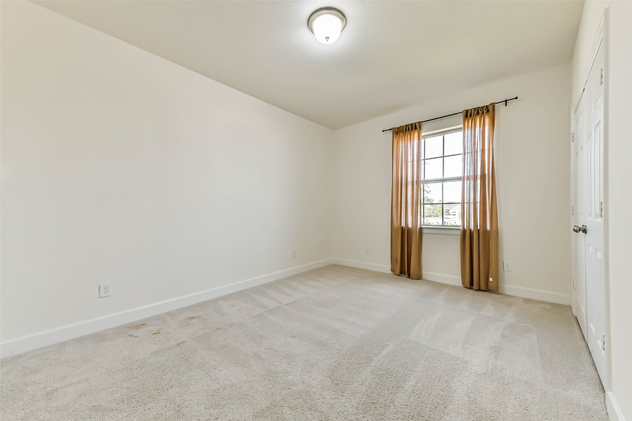 Bright and inviting secondary bedroom #4 featuring a cozy bed, stylish decor, and a large window with warm curtains that allow natural light to fill the space.