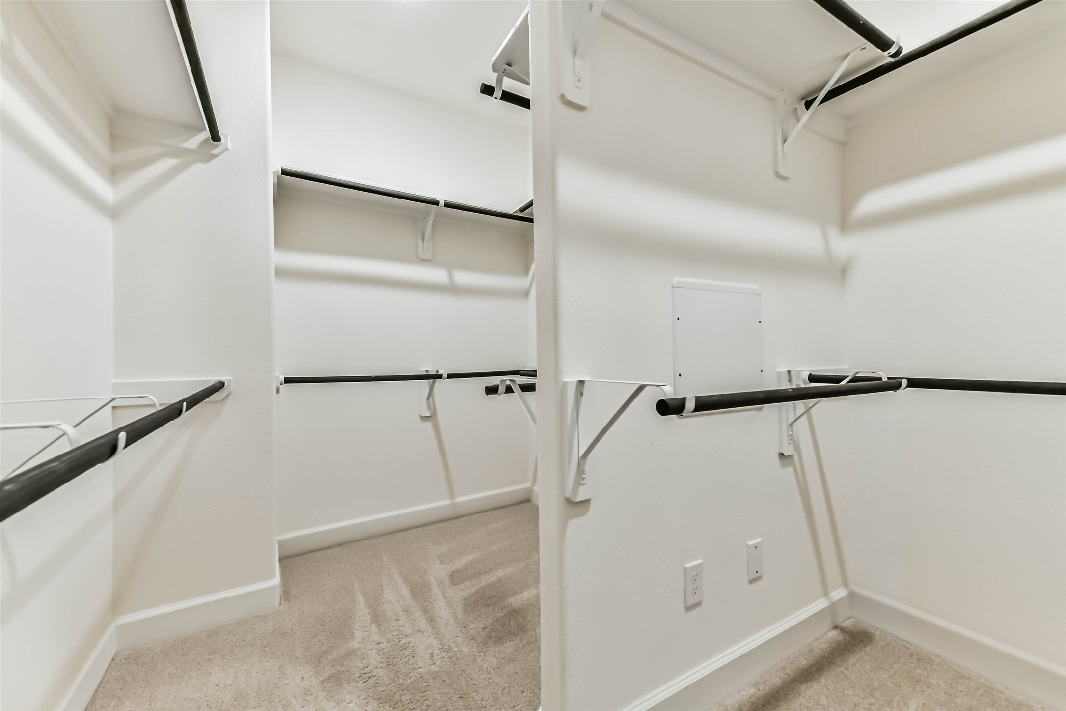Spacious walk-in closet with ample shelving and hanging space, perfect for organizing your wardrobe.