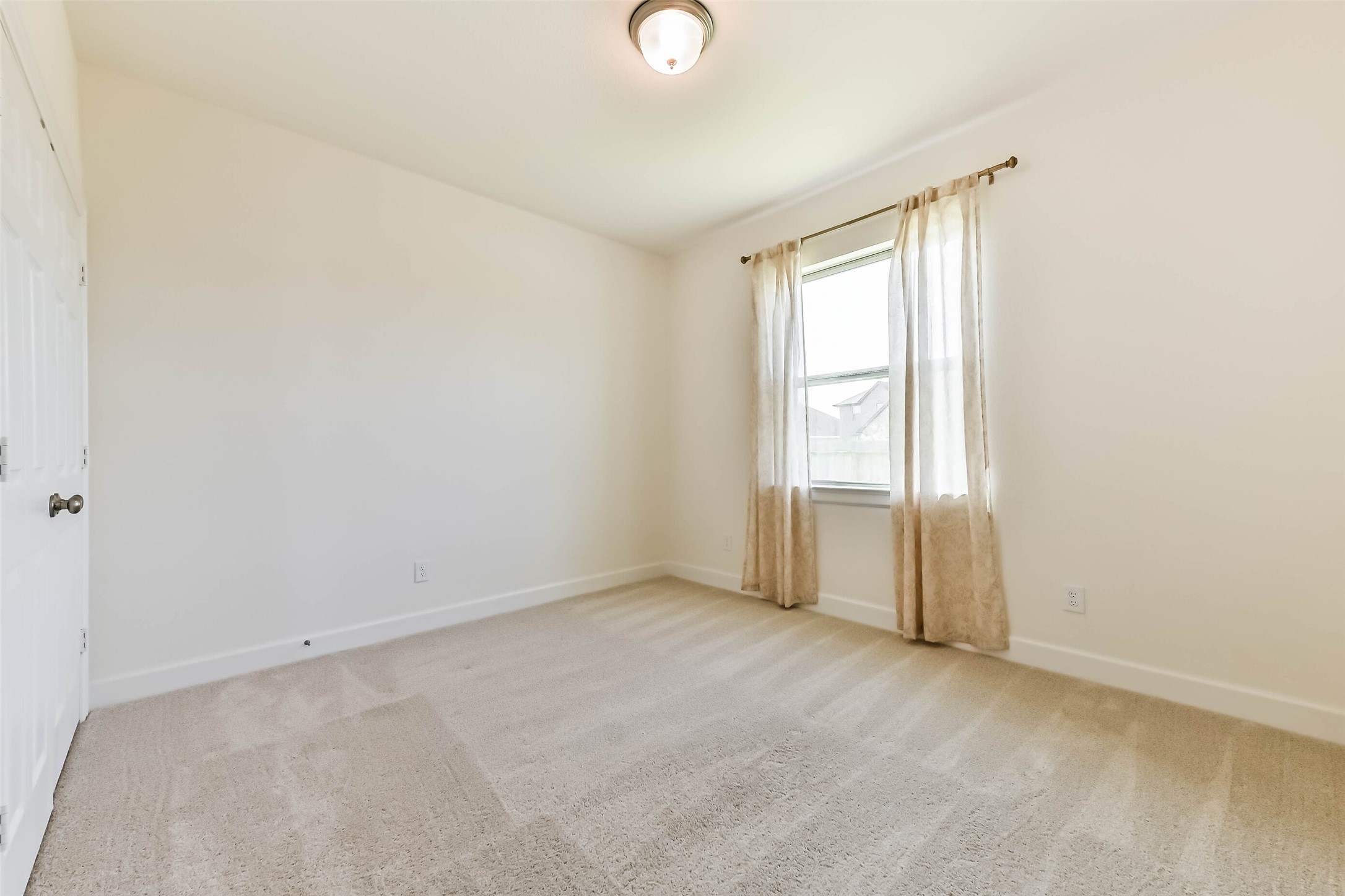 Spacious bedroom #2 with serene neutral finishes, generous layout, and abundant natural light