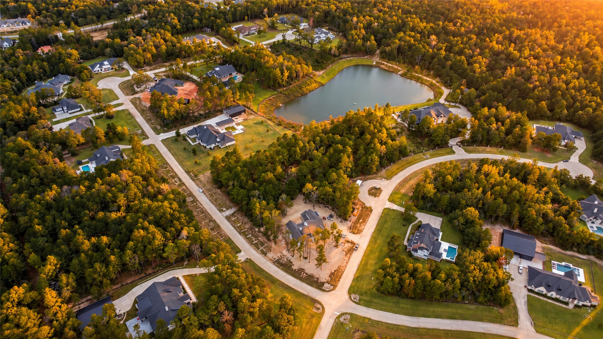 An aerial view captures the surrounding tree canopy and established homes of High Meadow Estates. An aerial view captures the surrounding tree canopy and established homes of High Meadow Estates.