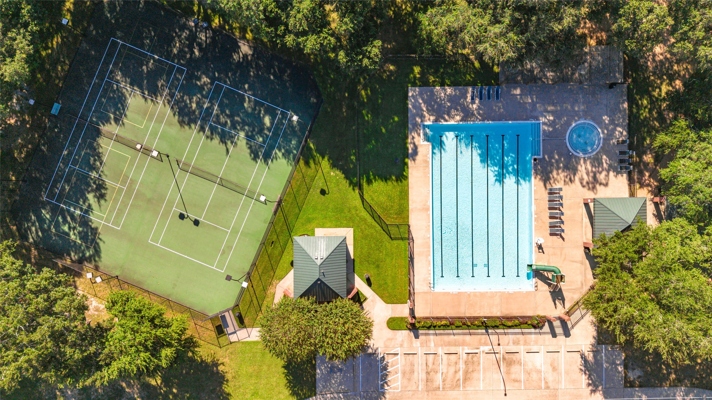 Experience resort-style living with access to a pristine pool, and well-maintained tennis courts, all surrounded by lush greenery for privacy and relaxation.