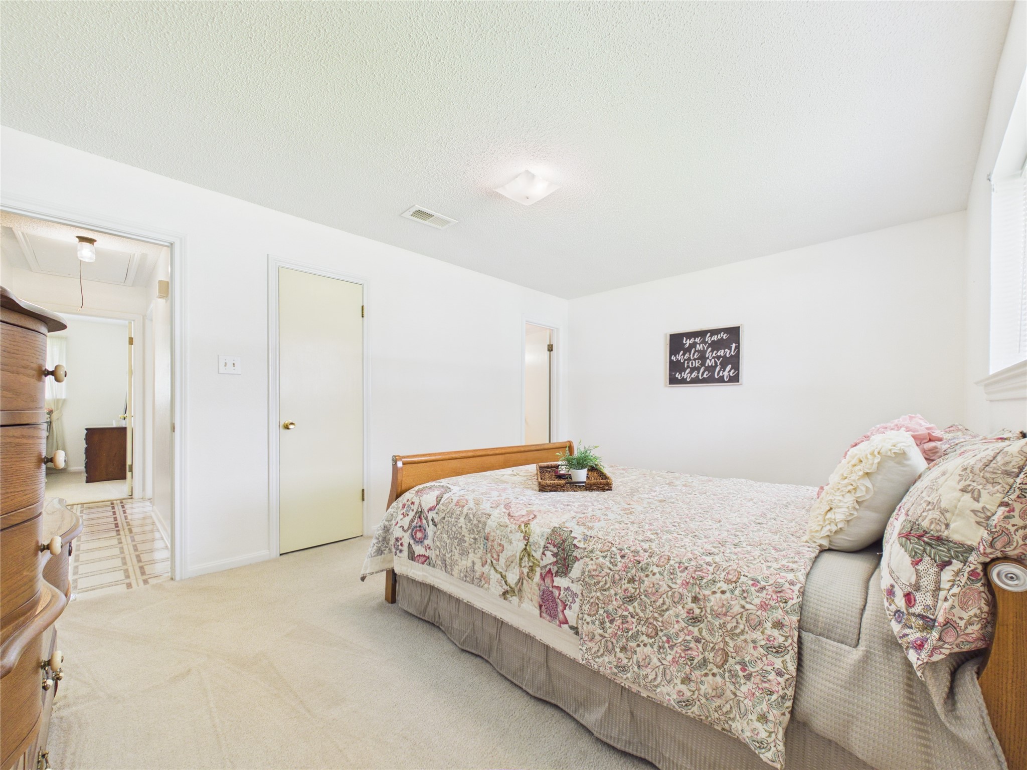 Another view of the primary suite, closed door is a walk in closet; open door leads to the primary bathroom