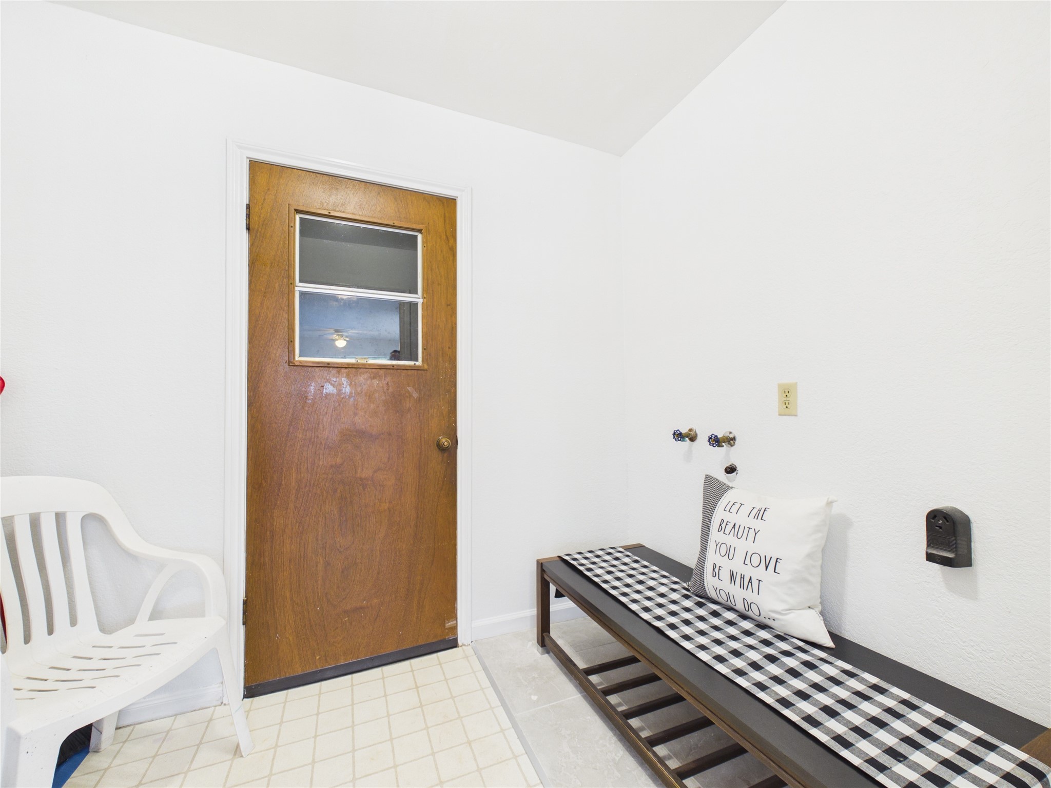 In house laundry room located just off the kitchen. This door leads to the two car garage that has a nice work bench/storage area and an added side door that gives access in/out without having to open the garage doors.