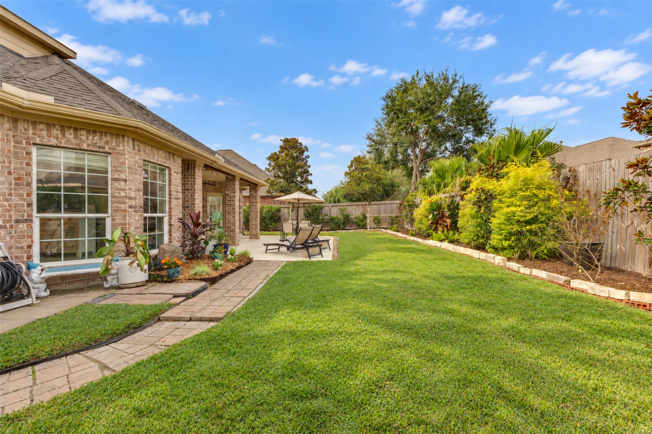 Lush landscaping and a spacious lawn provide a peaceful outdoor retreat.