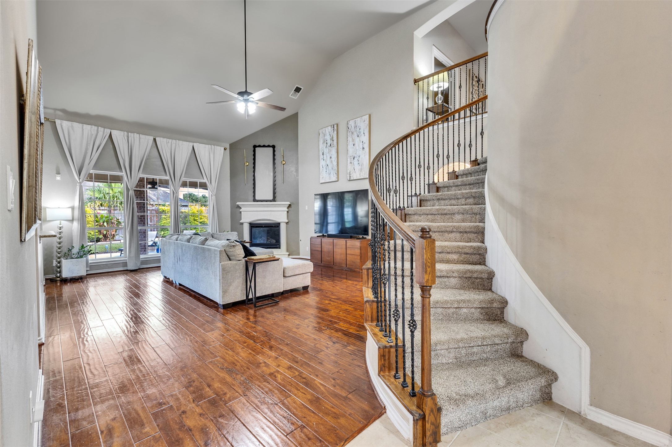 Soaring ceilings, beautiful wood floors, and a sweeping staircase create a stunning space for everyday living.