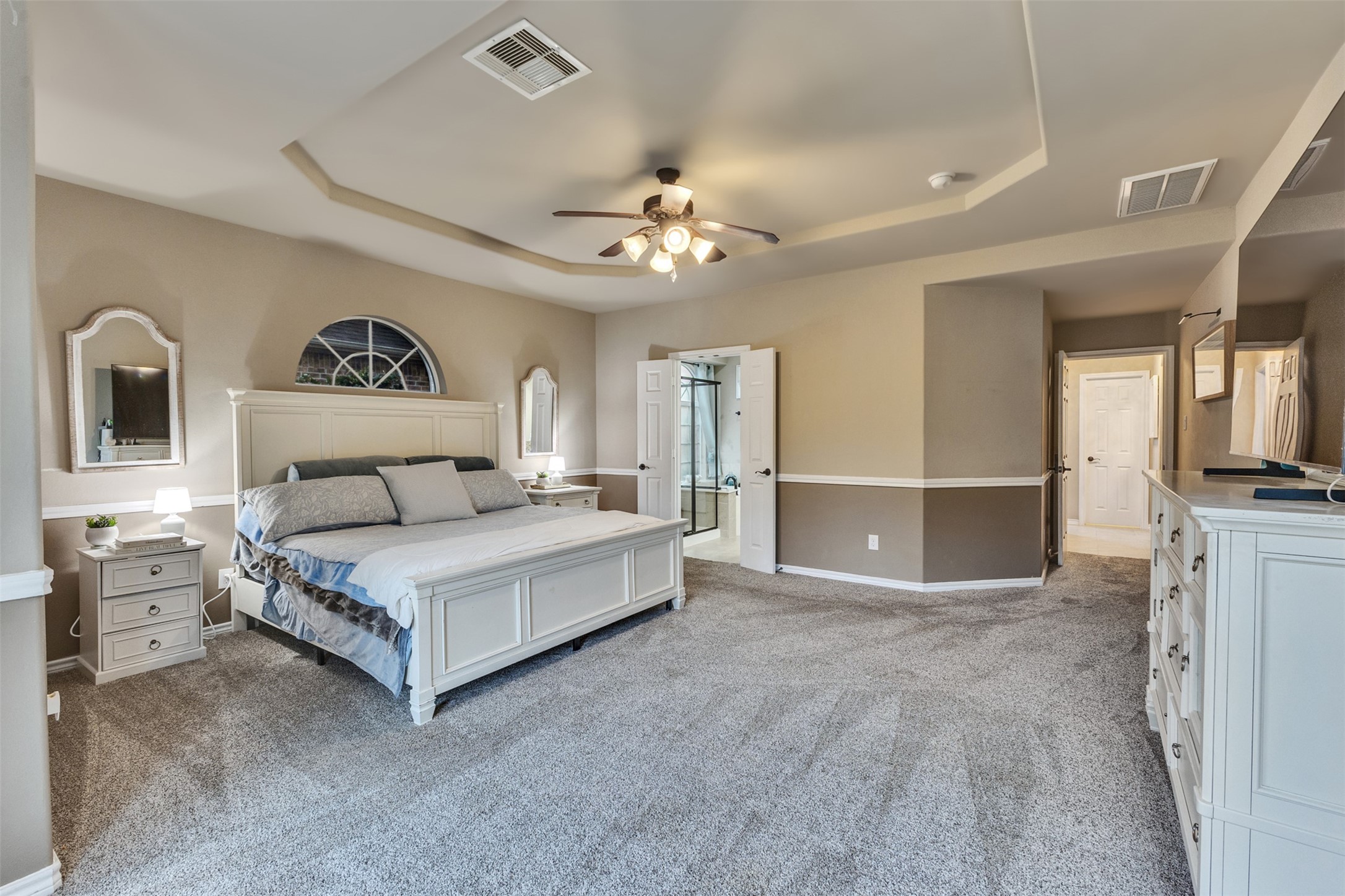 End each day in comfort with a generously sized bedroom, tray ceiling, and direct access to the ensuite bath.