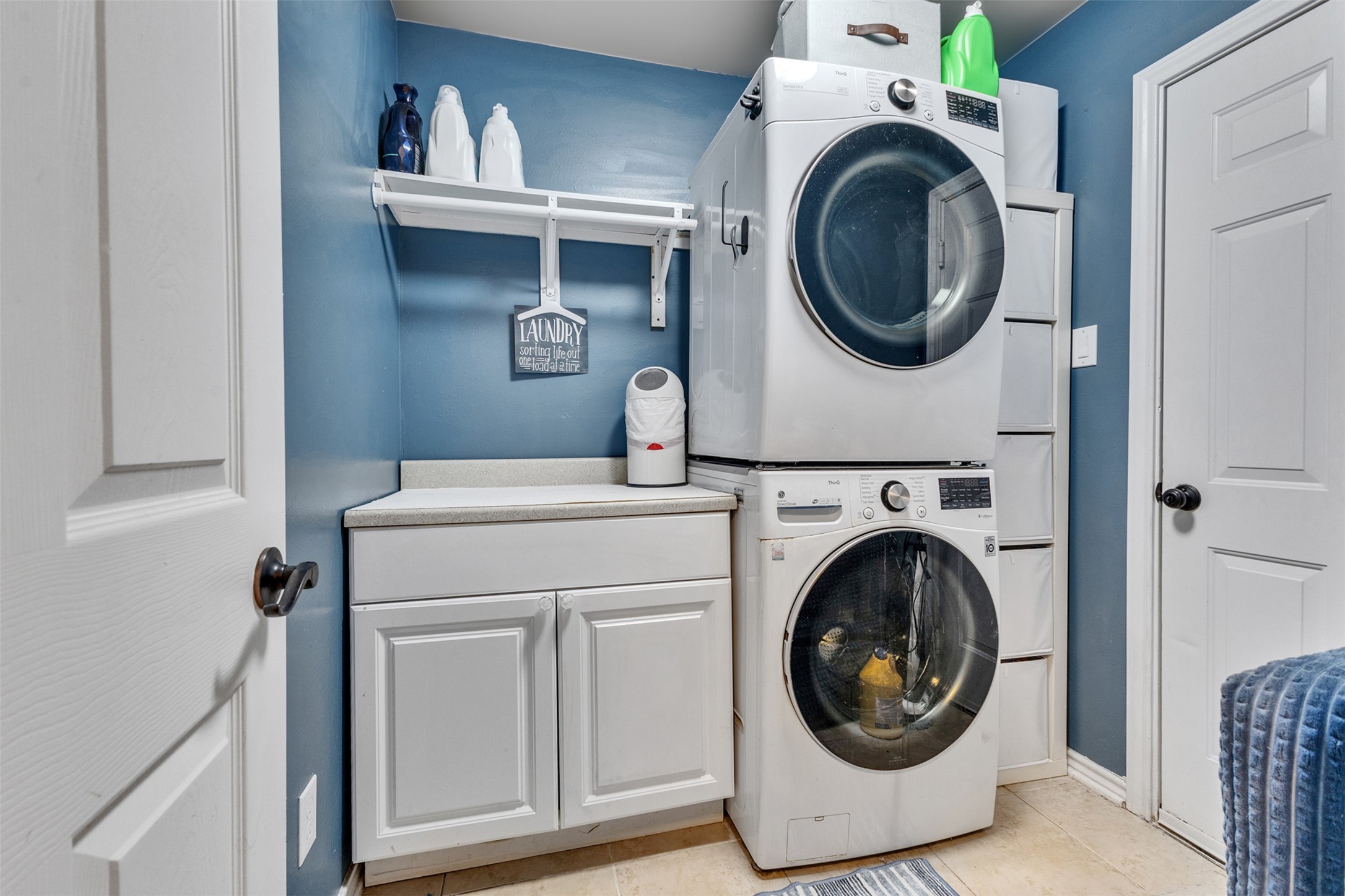 Laundry day made easier with convenient storage, folding space, and a space-saving stacked washer and dryer.