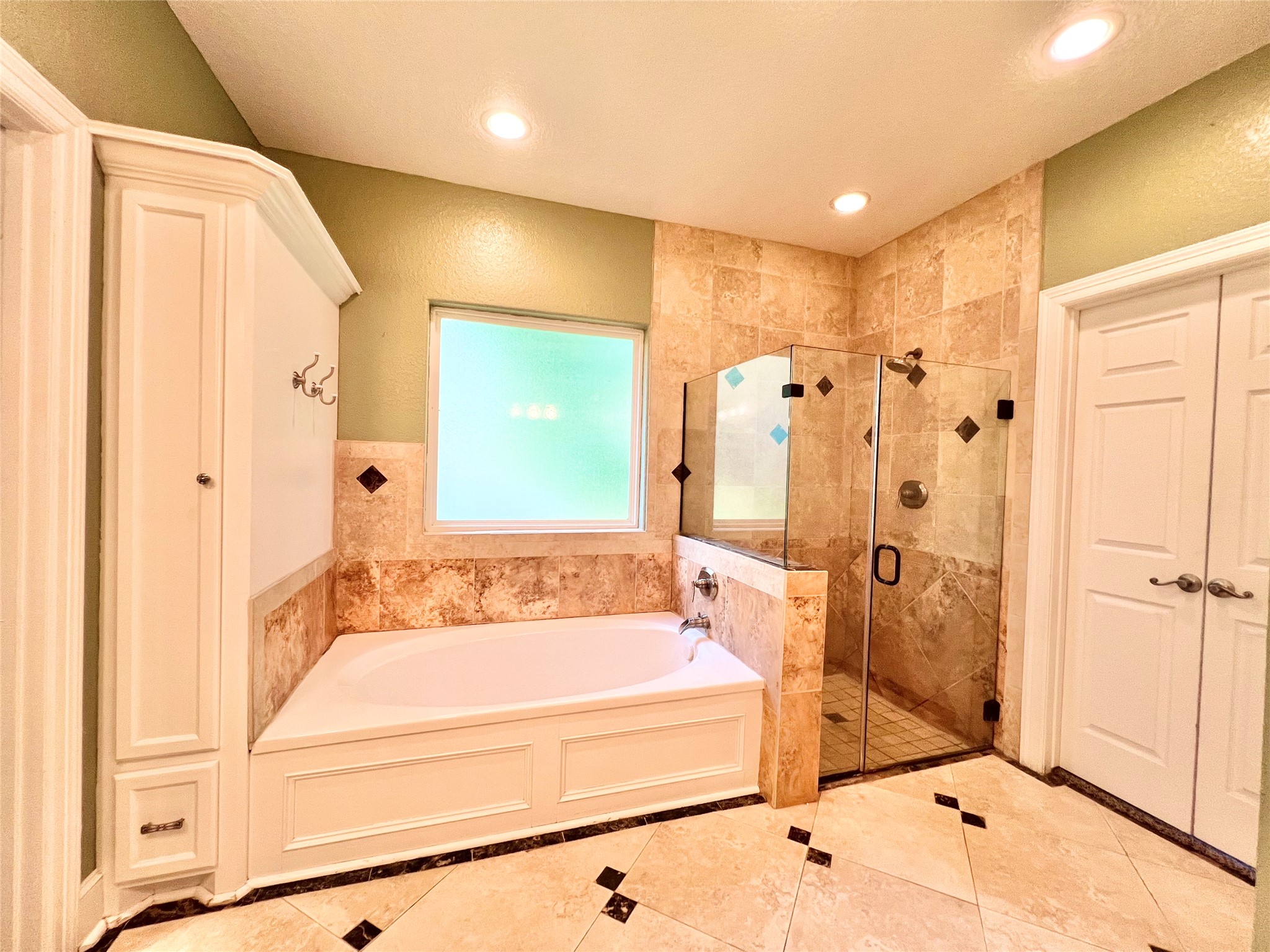 Oversized soaking tub and separate oversized shower as well.