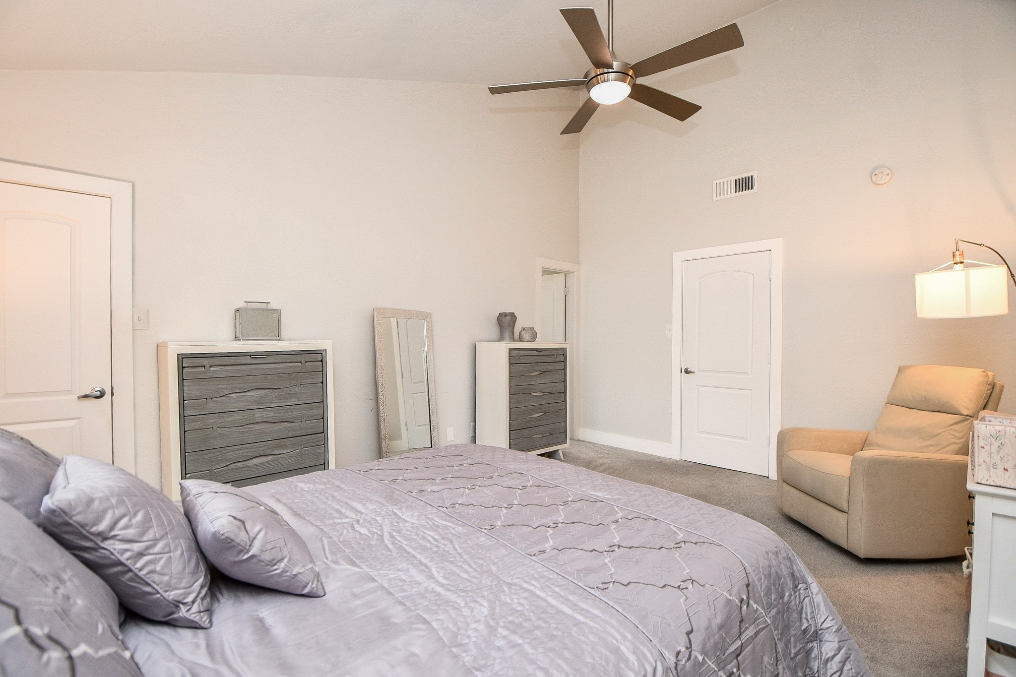 The primary bedroom has a vaulted ceiling and direct access to the en-suite bath.
