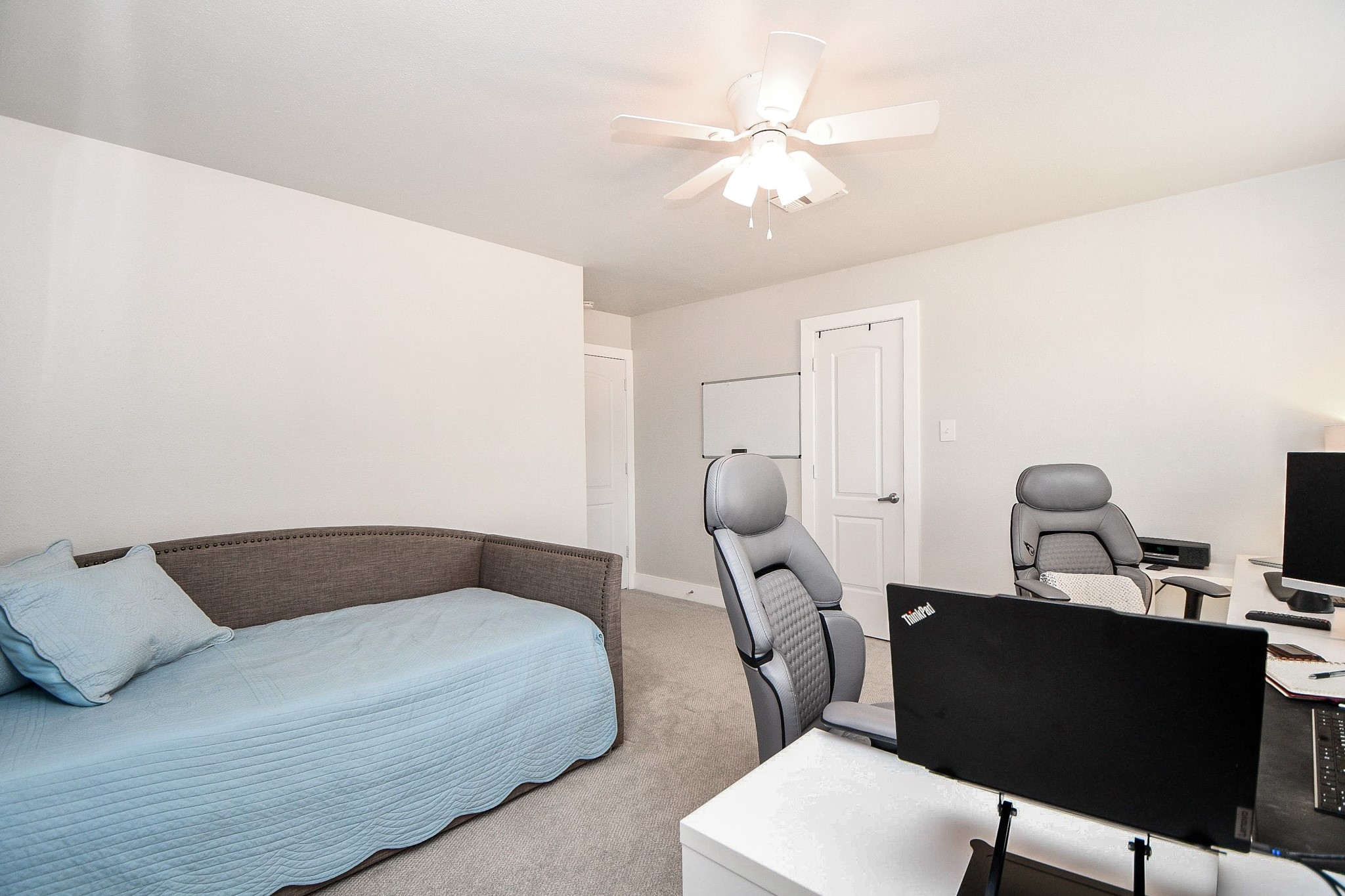 The second bedroom easily fits a desk area alongside a bed.