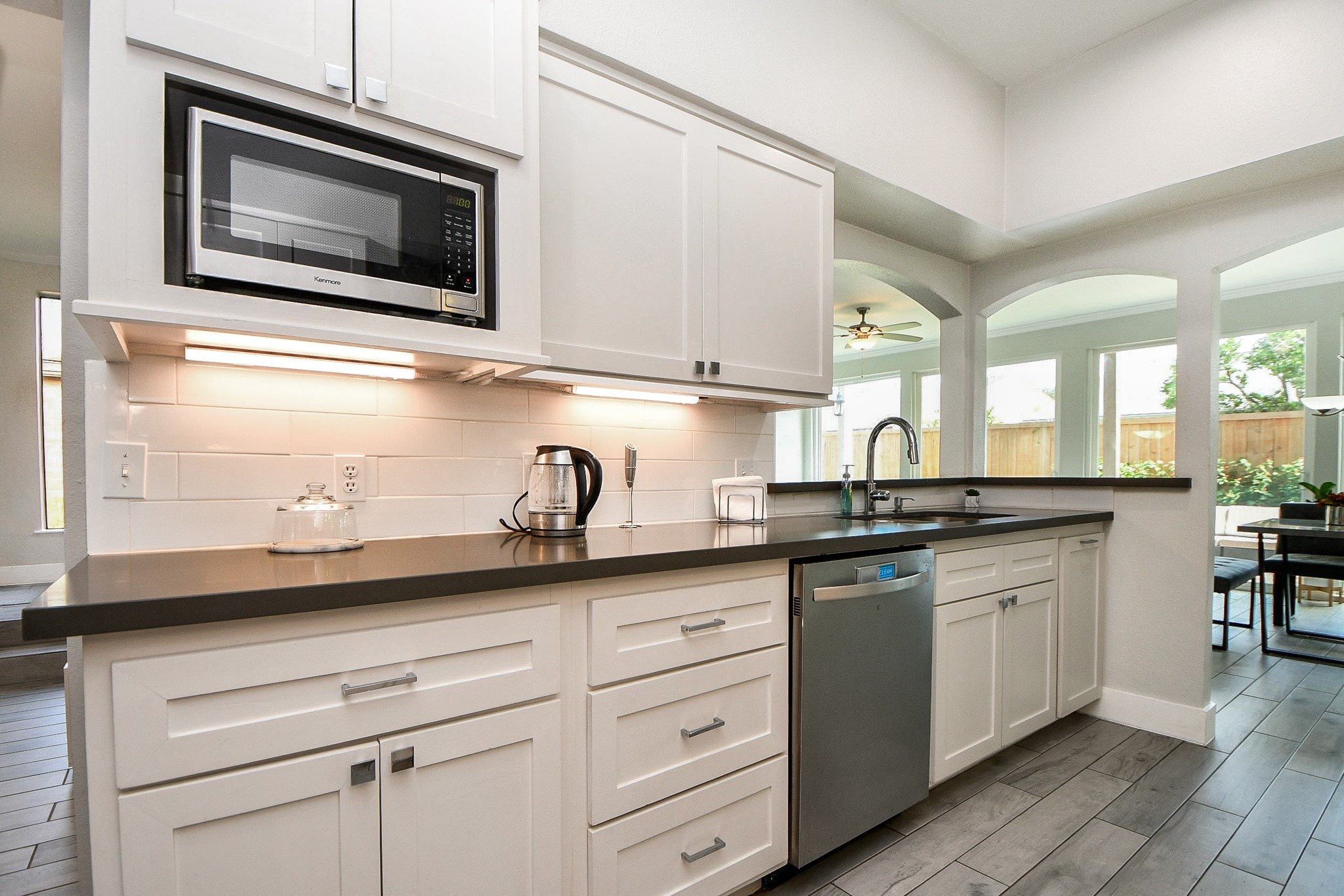 The kitchen has a vent hood, ample counter space, and a pass-through to the living room.