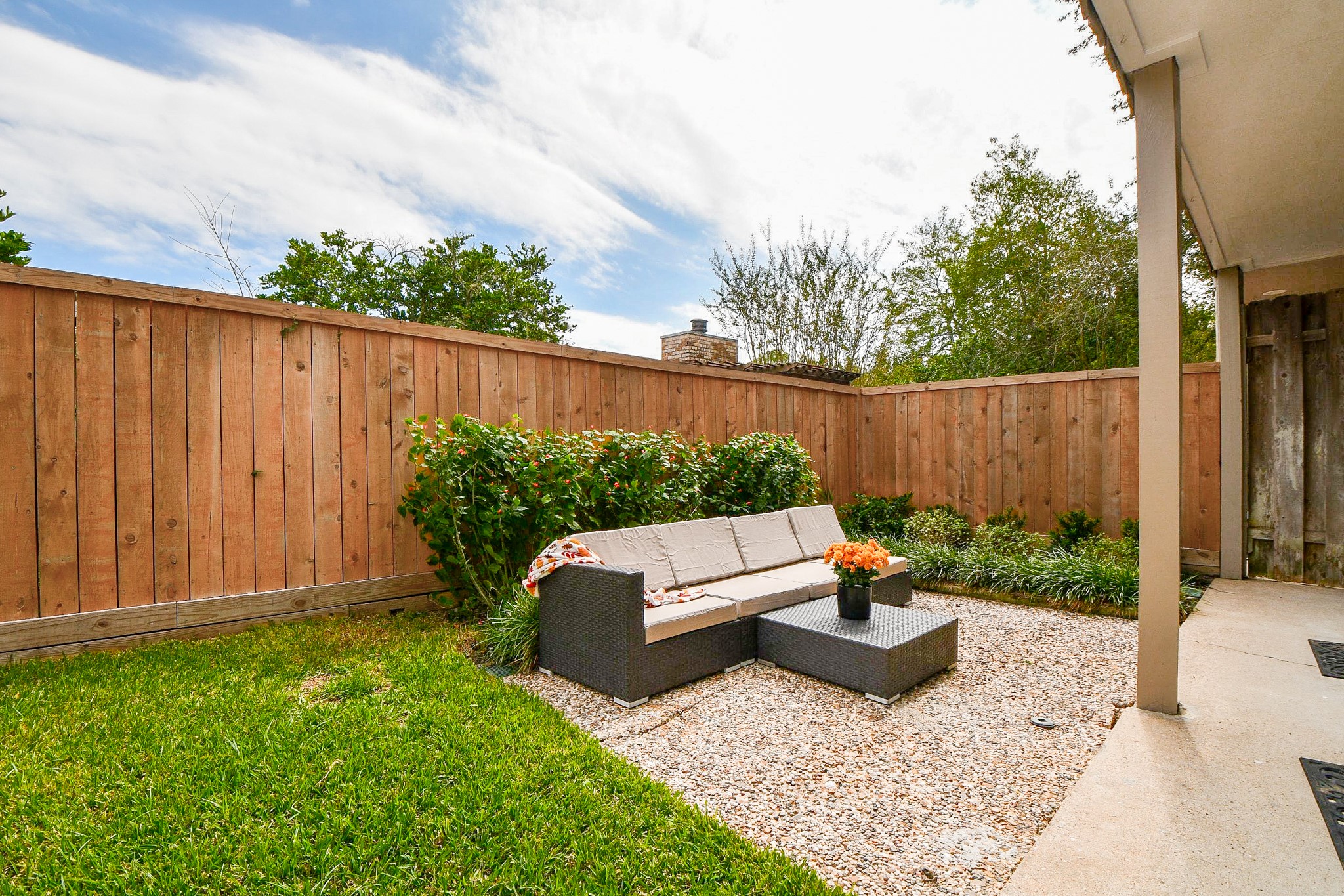 A covered rear patio runs along the back of the home.
