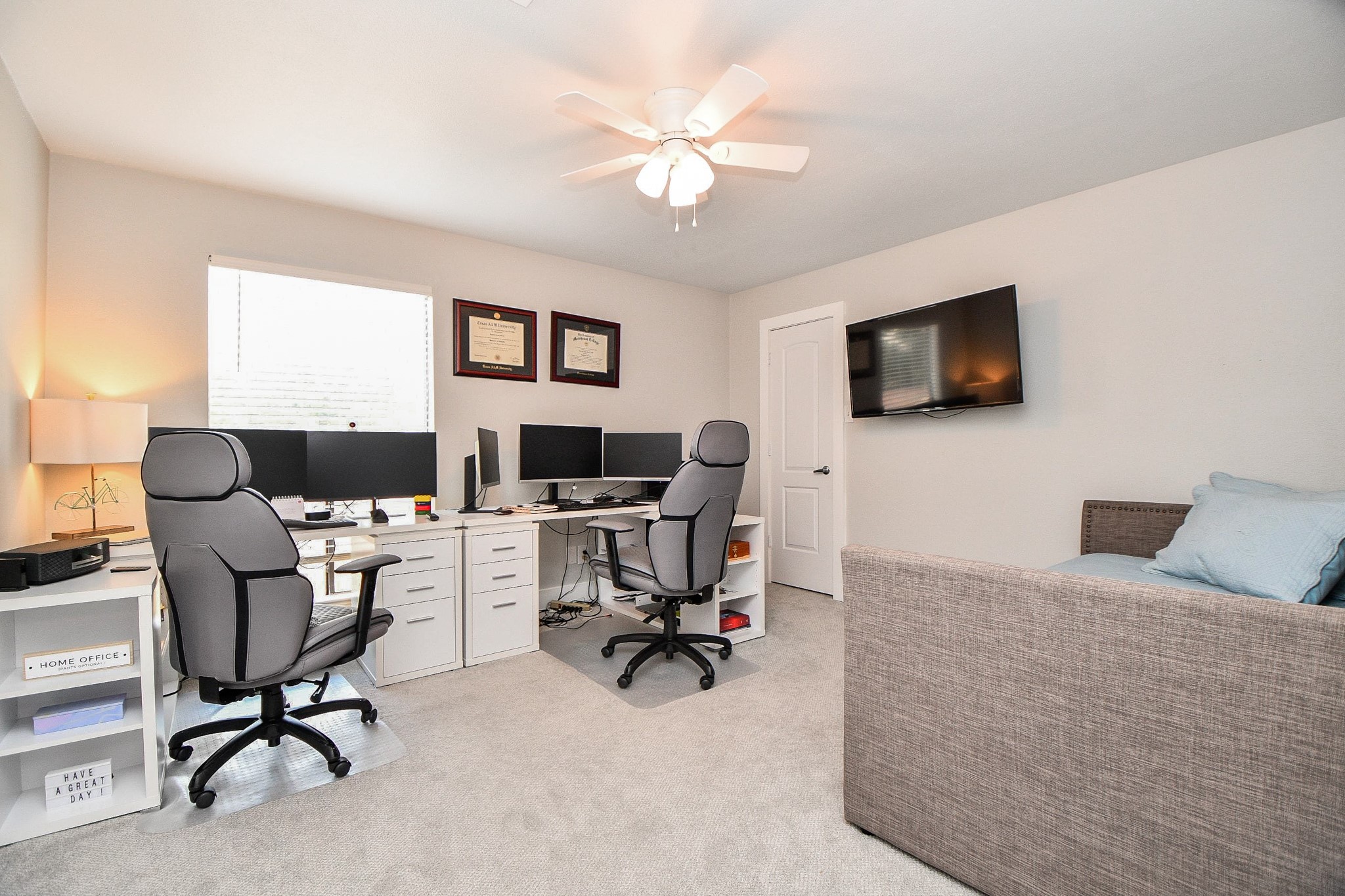 The second bedroom has a ceiling fan and a large window. It works well as a bedroom or a home office.