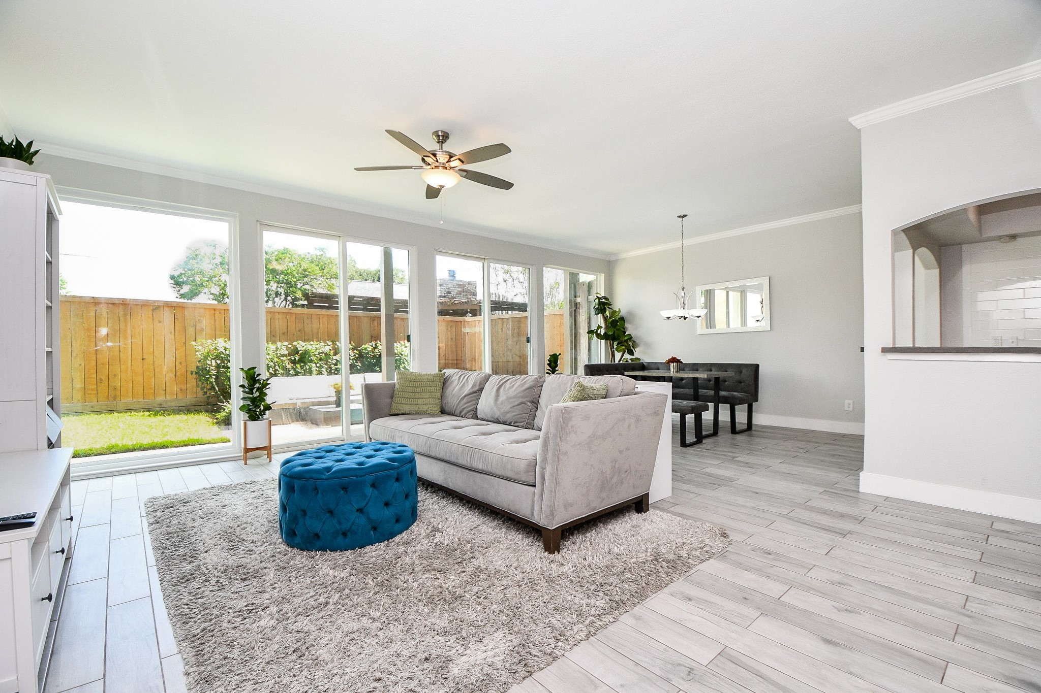 A view from the entry shows the staircase, the living room, and the kitchen beyond.