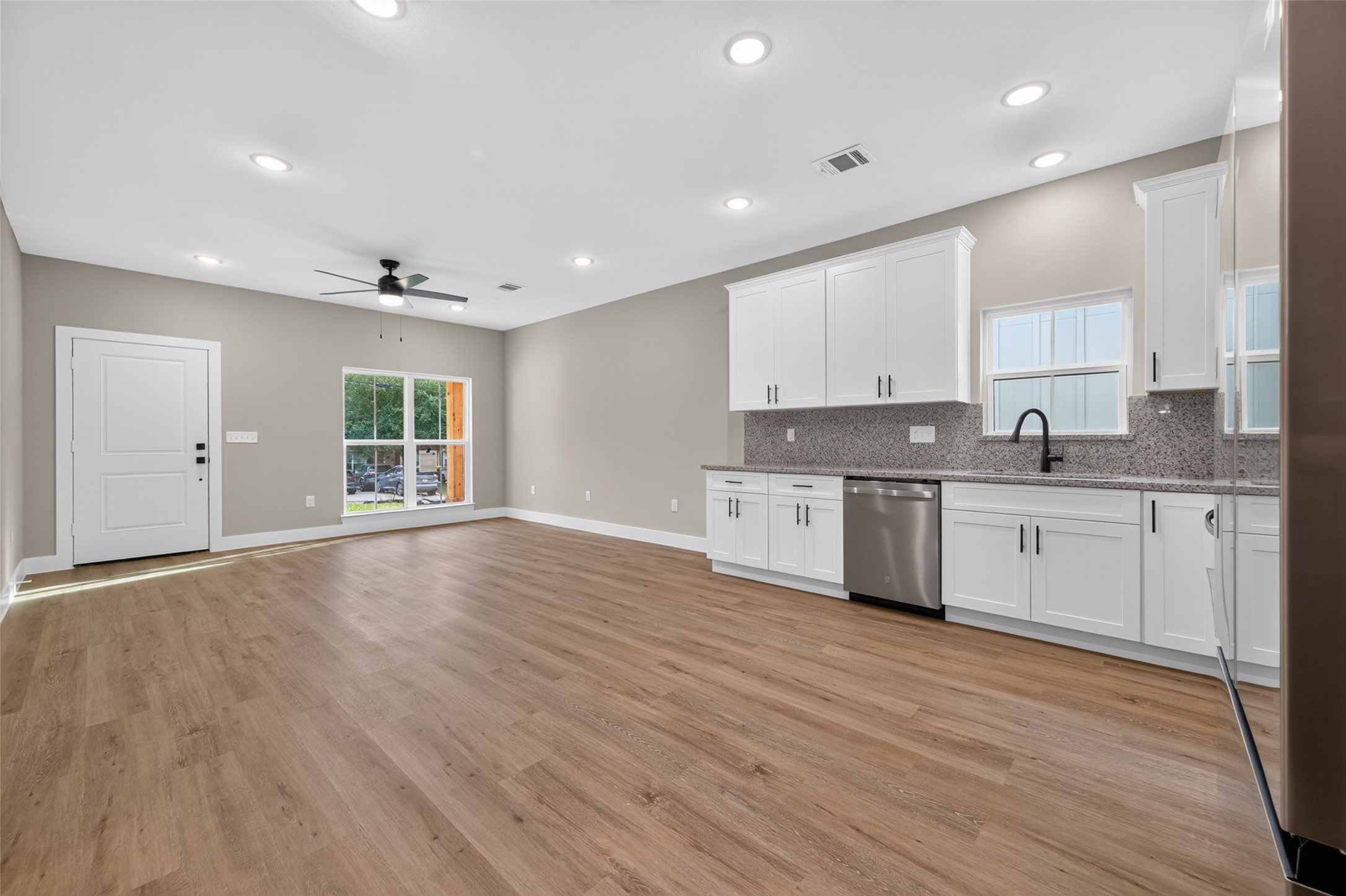 Open concept living, dining, and kitchen space.