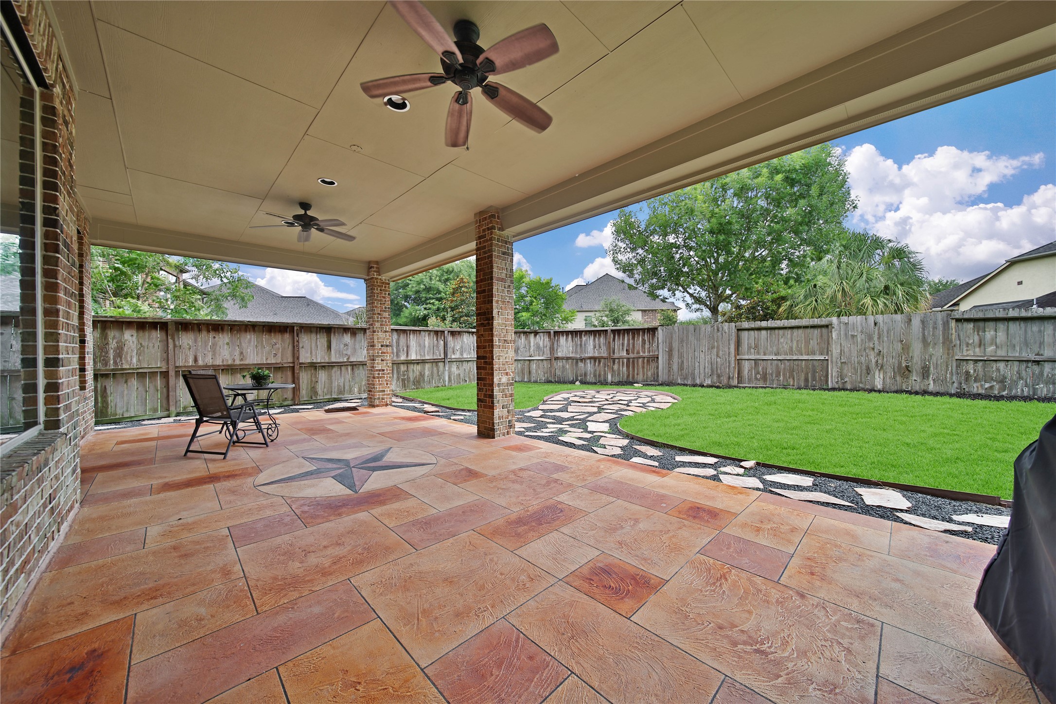 WOW! Expansive covered patio features two fans to keep the breeze circulating, creating the perfect outdoor space for relaxing and entertaining. A walkway along the left side of the home Now this is a patio! The expaprovides a nice buffer from neighbors while adding to the spacious feel and privacy of the backyard. Exterior Gas Stub allows for future outdoor kitchen.