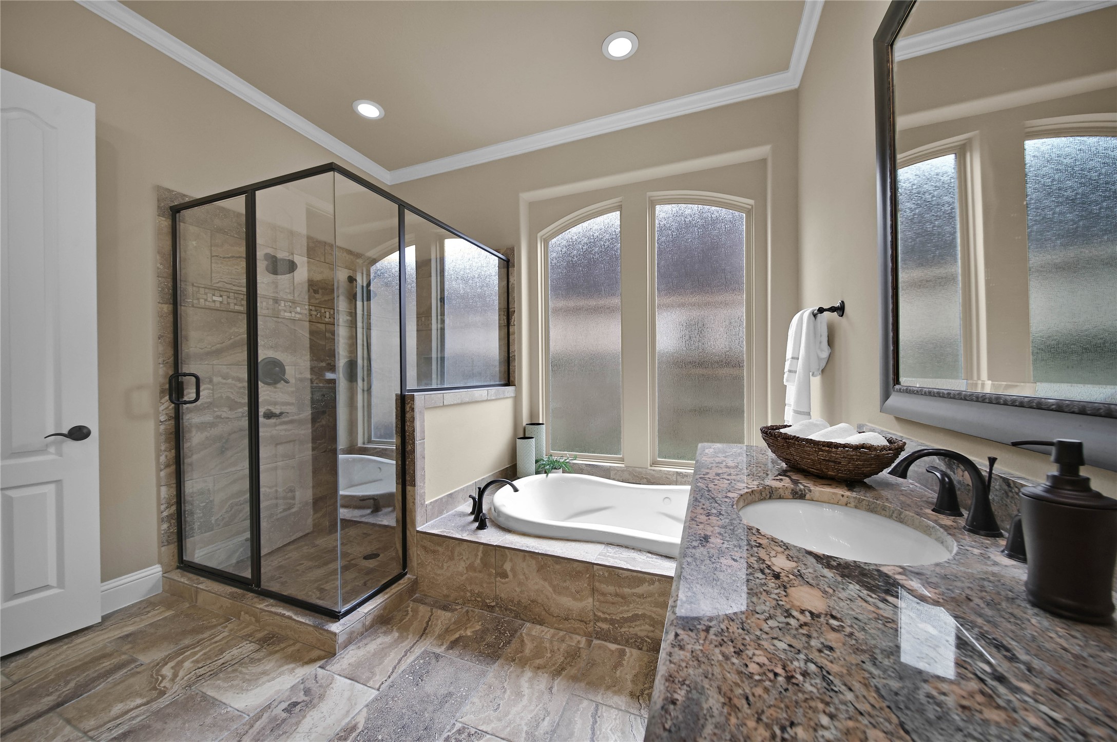 The primary bath offers the perfect place to relax and rejuvenate with a luxurious jetted tub and a separate shower with dual shower heads designed for comfort and convenience.