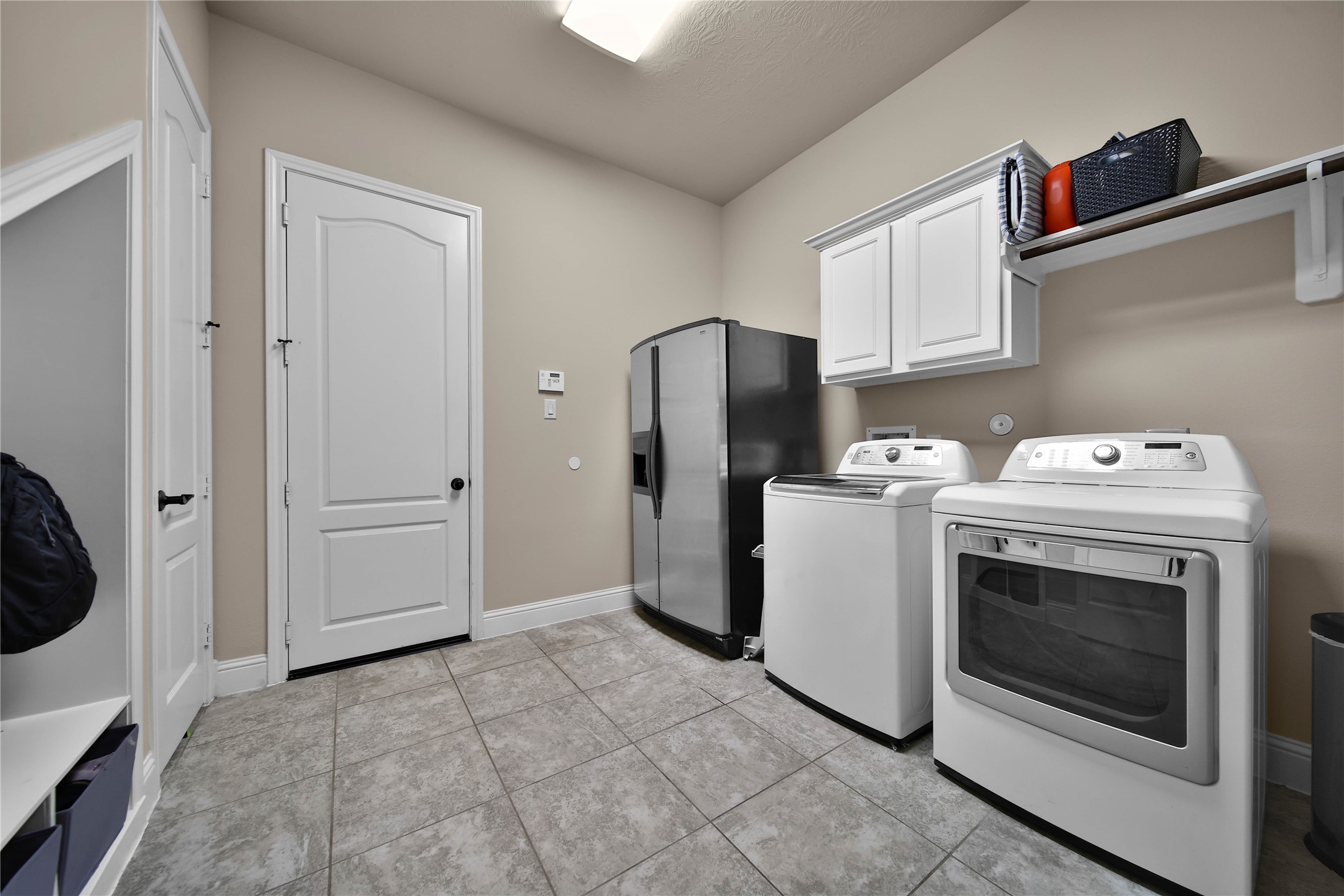 The extra-large utility room is conveniently located right off the garage and features a built-in mud organizer, perfect for storing backpacks, jackets, and shoes. A spacious walk-in closet provides additional storage for cleaning supplies and household essentials, keeping everything organized and within reach.