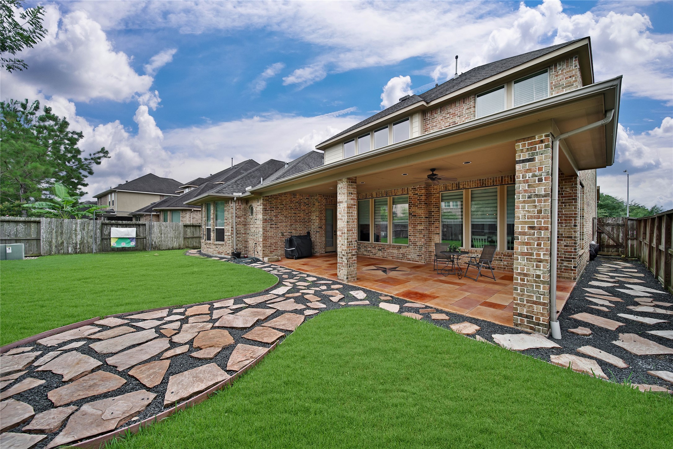**Note: Seller is happy to remove flagstone/ rocks and resod the backyard with grass if a buyer prefers! Flagstone and rock create a charming walkway along the side of the home and a designated seating area in the backyard. These features add character and functionality while remaining flexible and easily removable should you choose to redesign the outdoor space in the future.