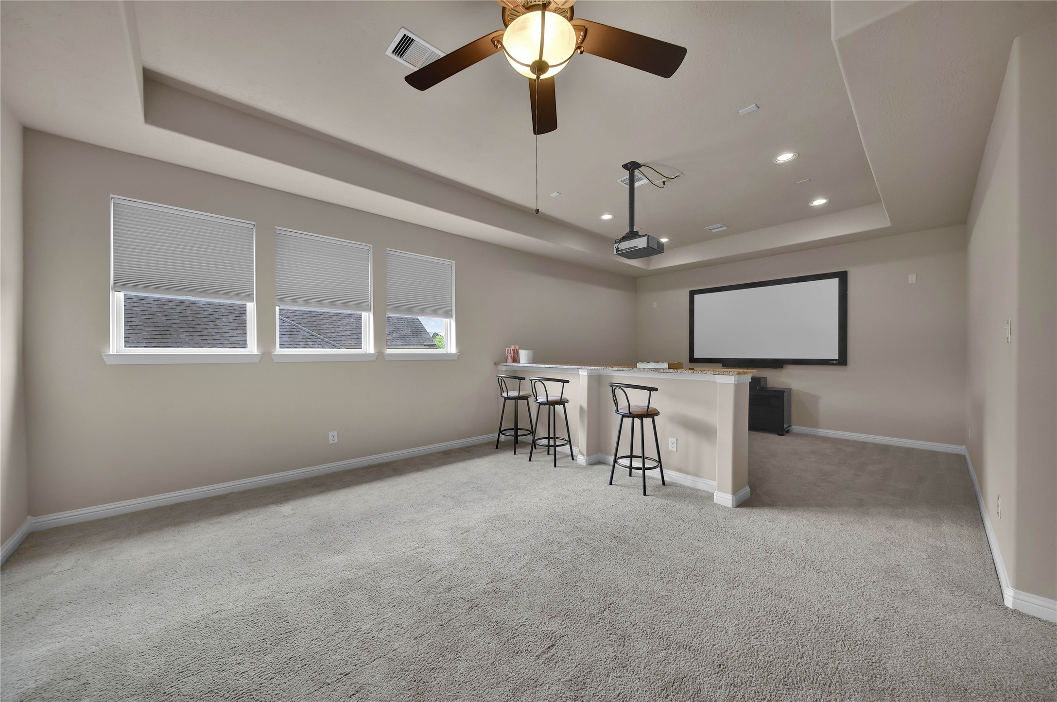 The gameroom/media area features a convenient half-wall countertop that beautifully defines the spaces while providing additional seating and eating areas for both rooms. This versatile design is perfect for entertaining, game nights, or relaxing with family and friends.