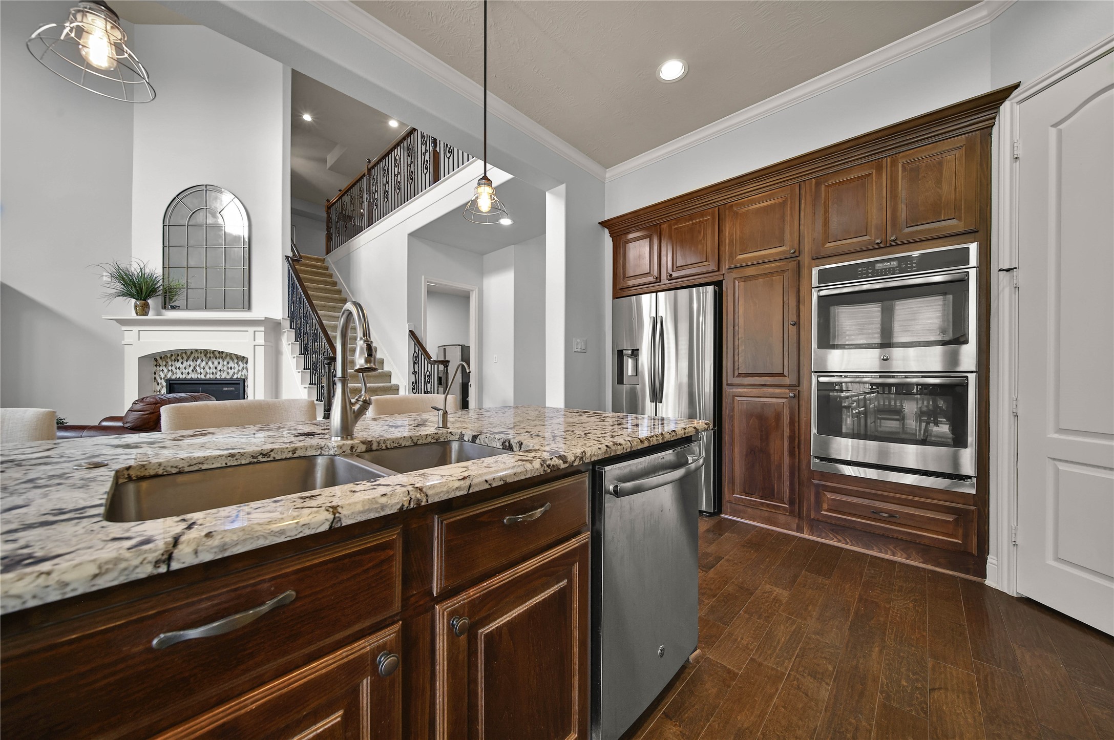 Stainless steel GE appliances complete this impressive kitchen, including double ovens, a microwave, a 5-burner gas cooktop, and a dishwasher. These high-quality features provide both style and functionality for the ultimate cooking experience.