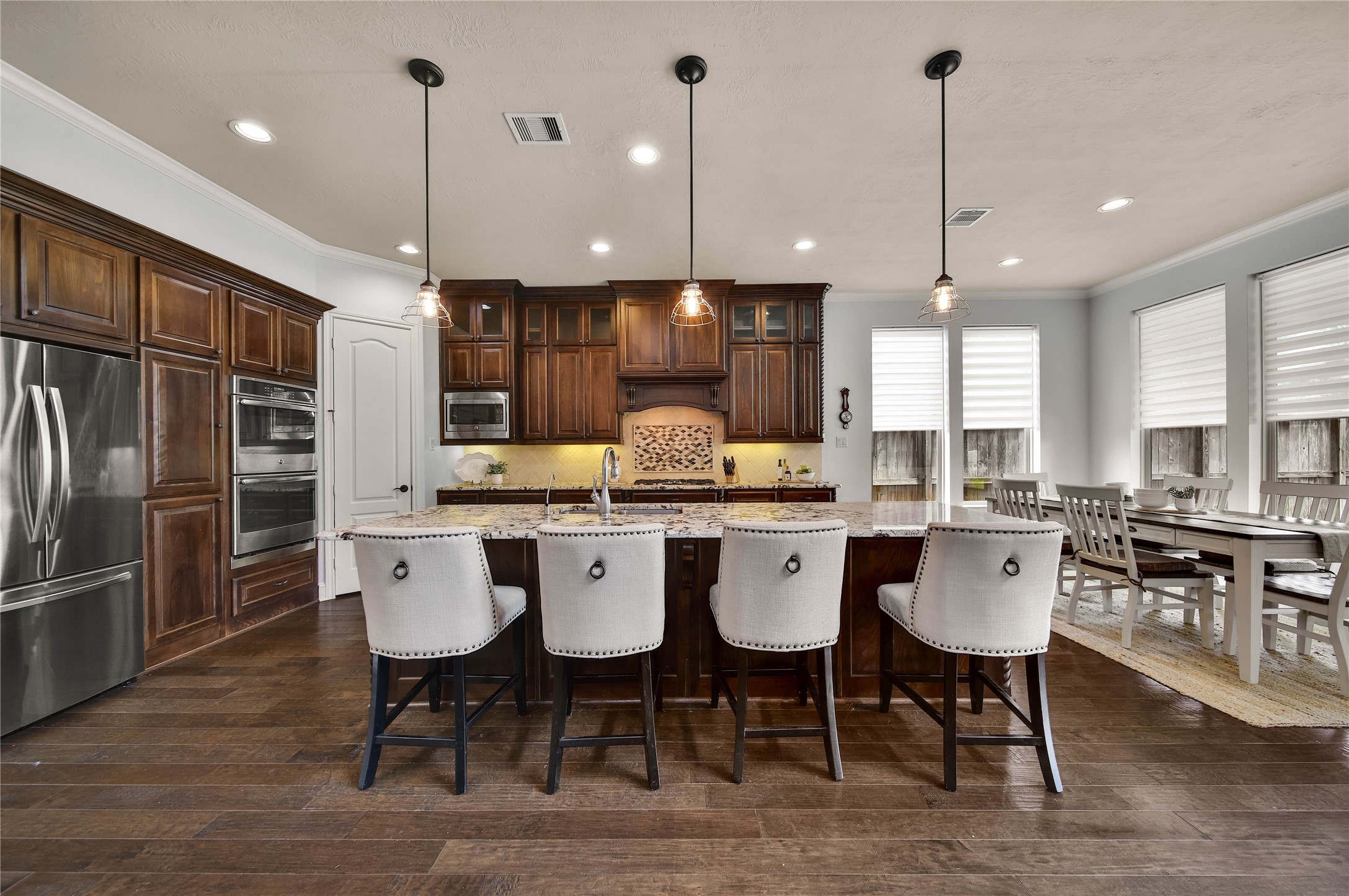 This gourmet kitchen with an oversized center island is every chefs dream, offering an abundance of space for meal preparation, entertaining, and gathering with family and friends.