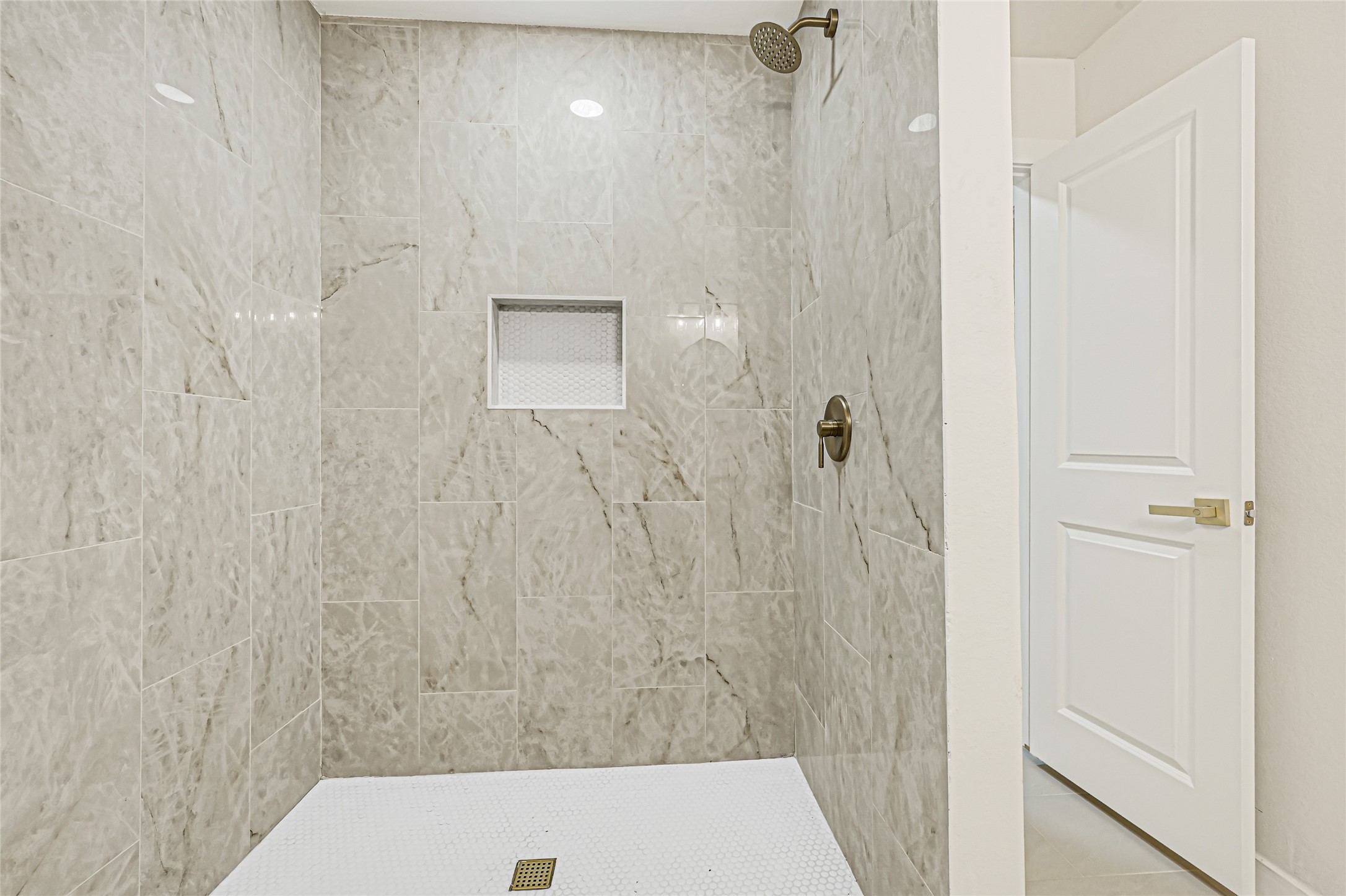 Second primary bathroom featuring a beautifully tiled walk-in shower.