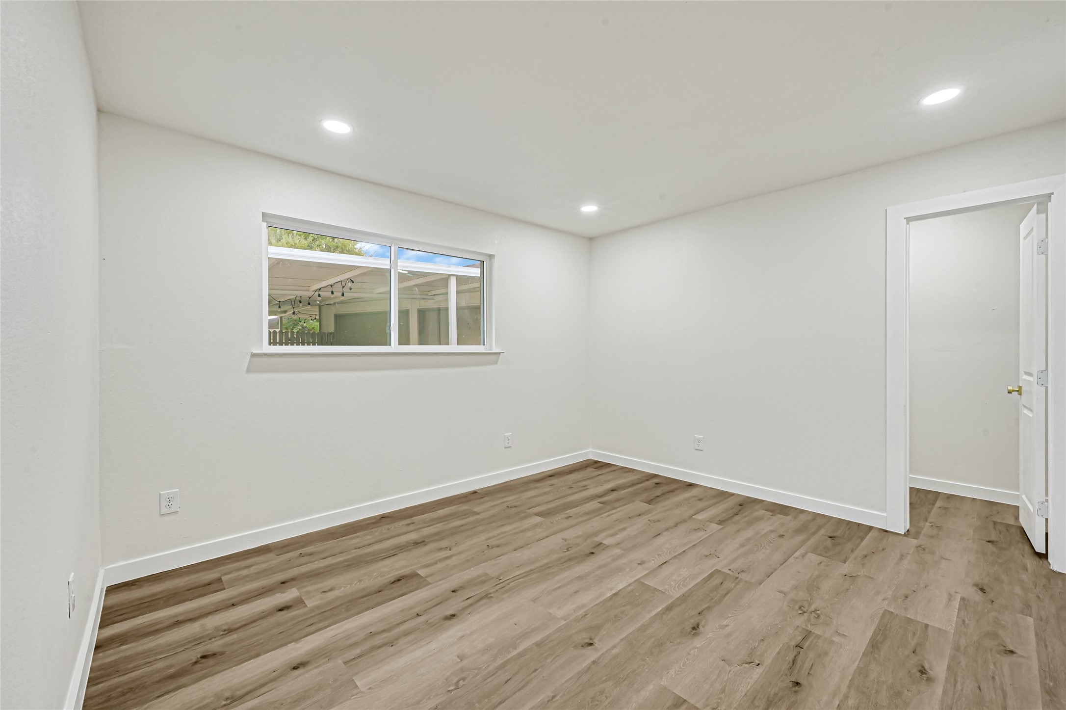 Second primary suite featuring updated flooring, recessed lighting, and a private bathroom