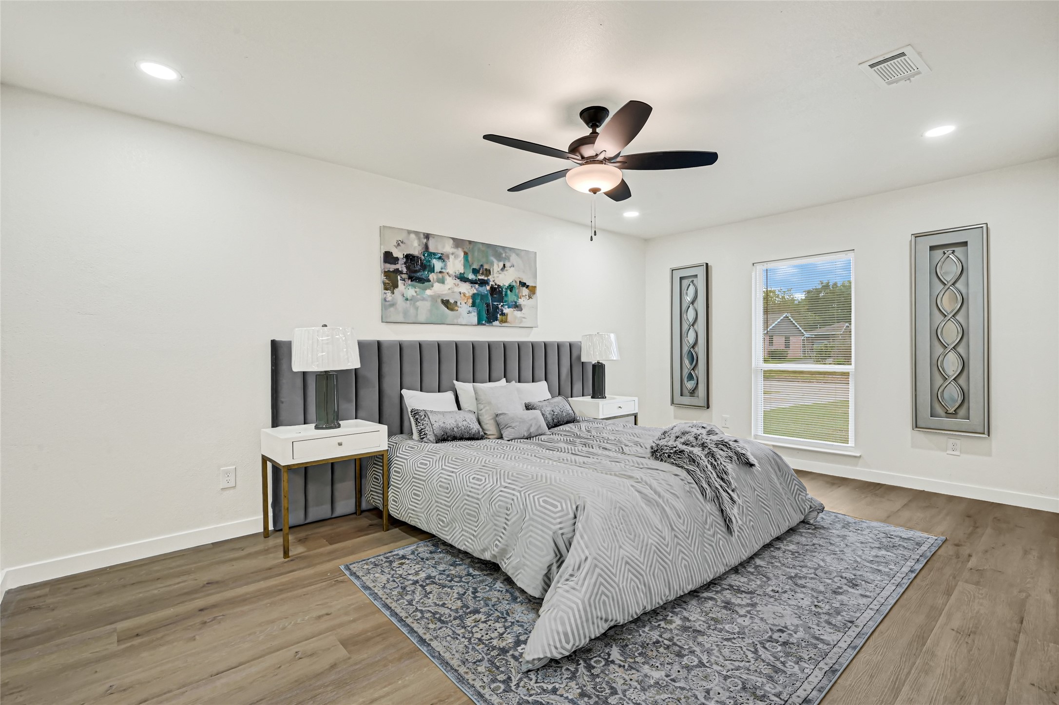 Spacious primary suite featuring modern finishes, updated flooring, and abundant natural lighting.