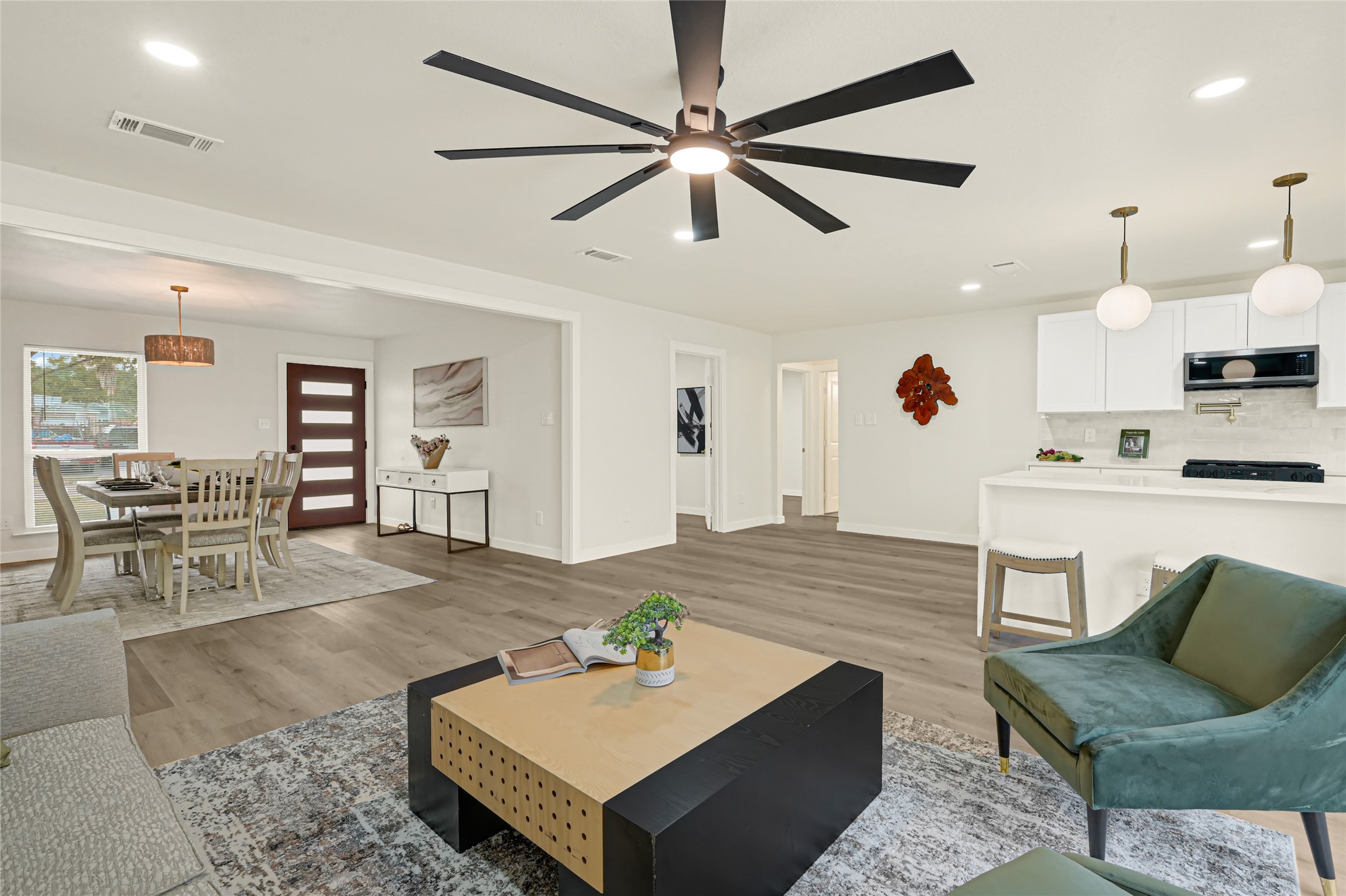 Bright and spacious open-concept living area seamlessly connecting the kitchen and dining space, perfect for everyday living and entertaining.