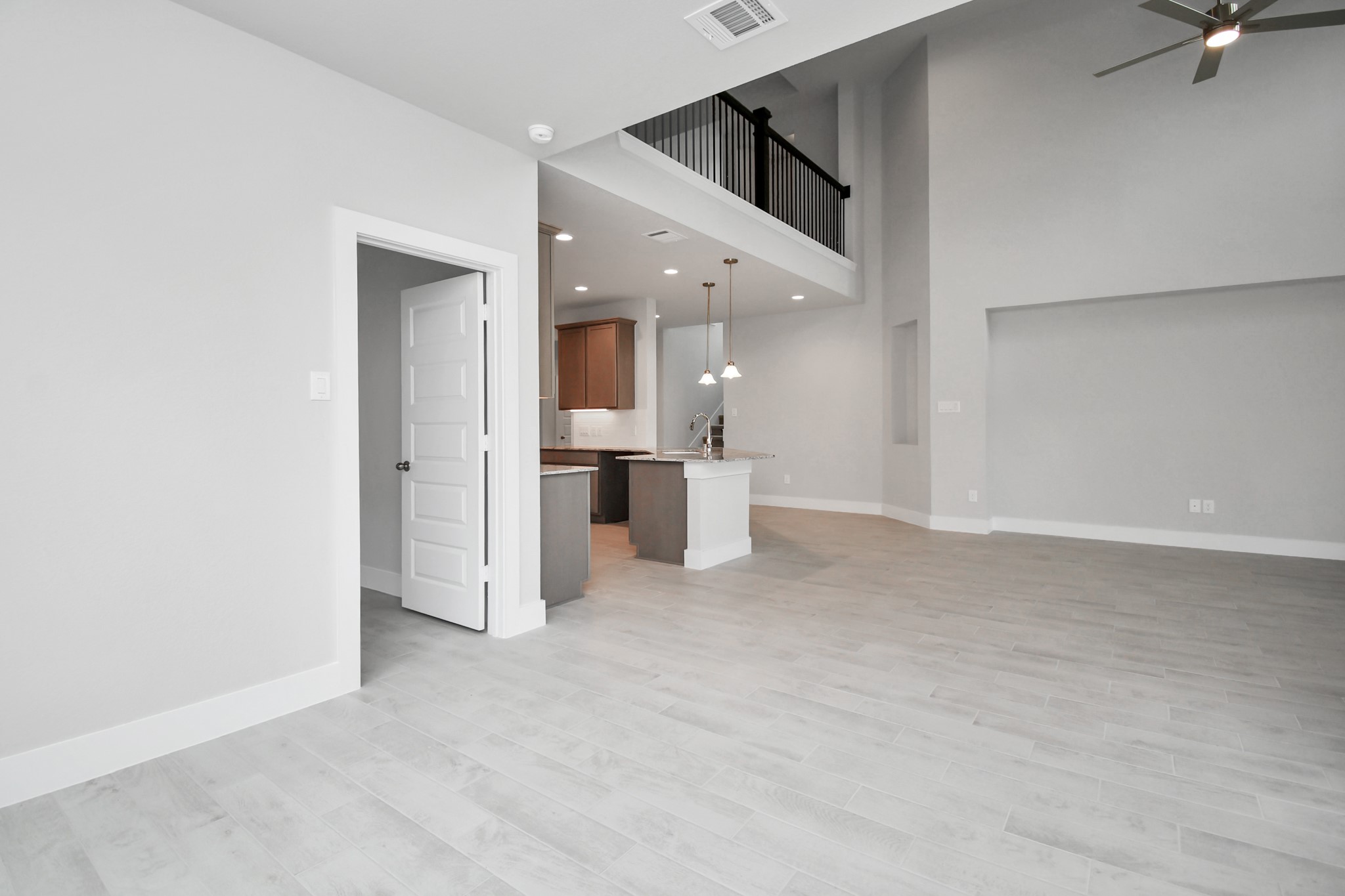 View from the breakfast area to the kitchen and living room. Sample photo of completed home with similar floor plan. Actual colors and selections may vary.