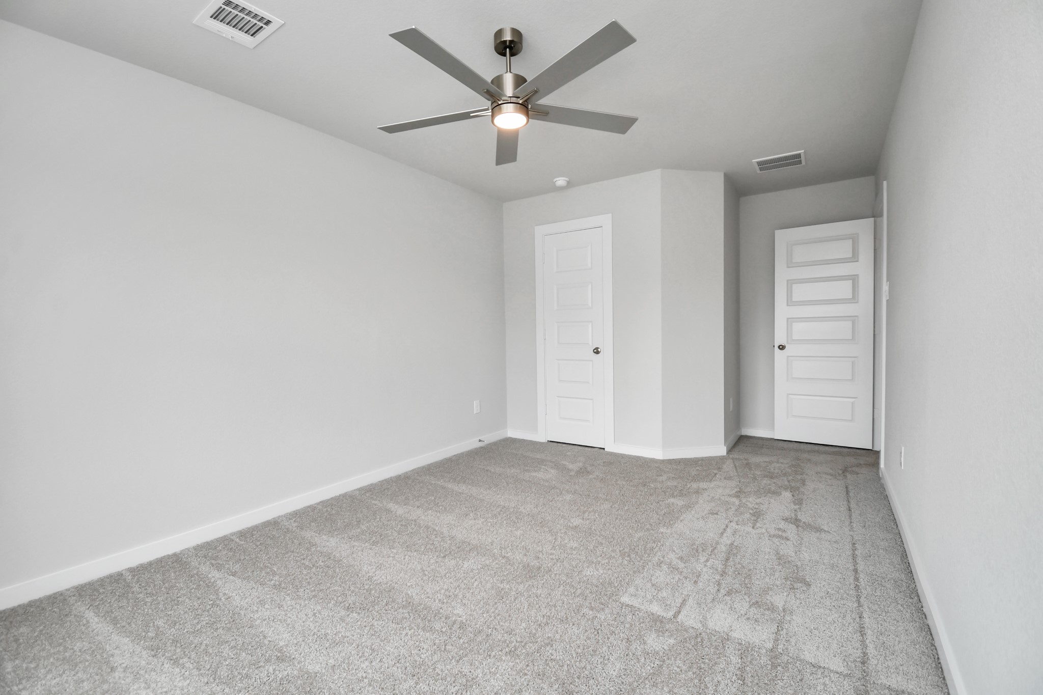 Generously sized secondary bedrooms featuring spacious closets, soft and inviting carpeting underfoot, large windows allowing plenty of natural light, and the added touch of privacy blinds for your personal retreat. Sample photo of completed home with similar floor plan. Actual colors and selections may vary.