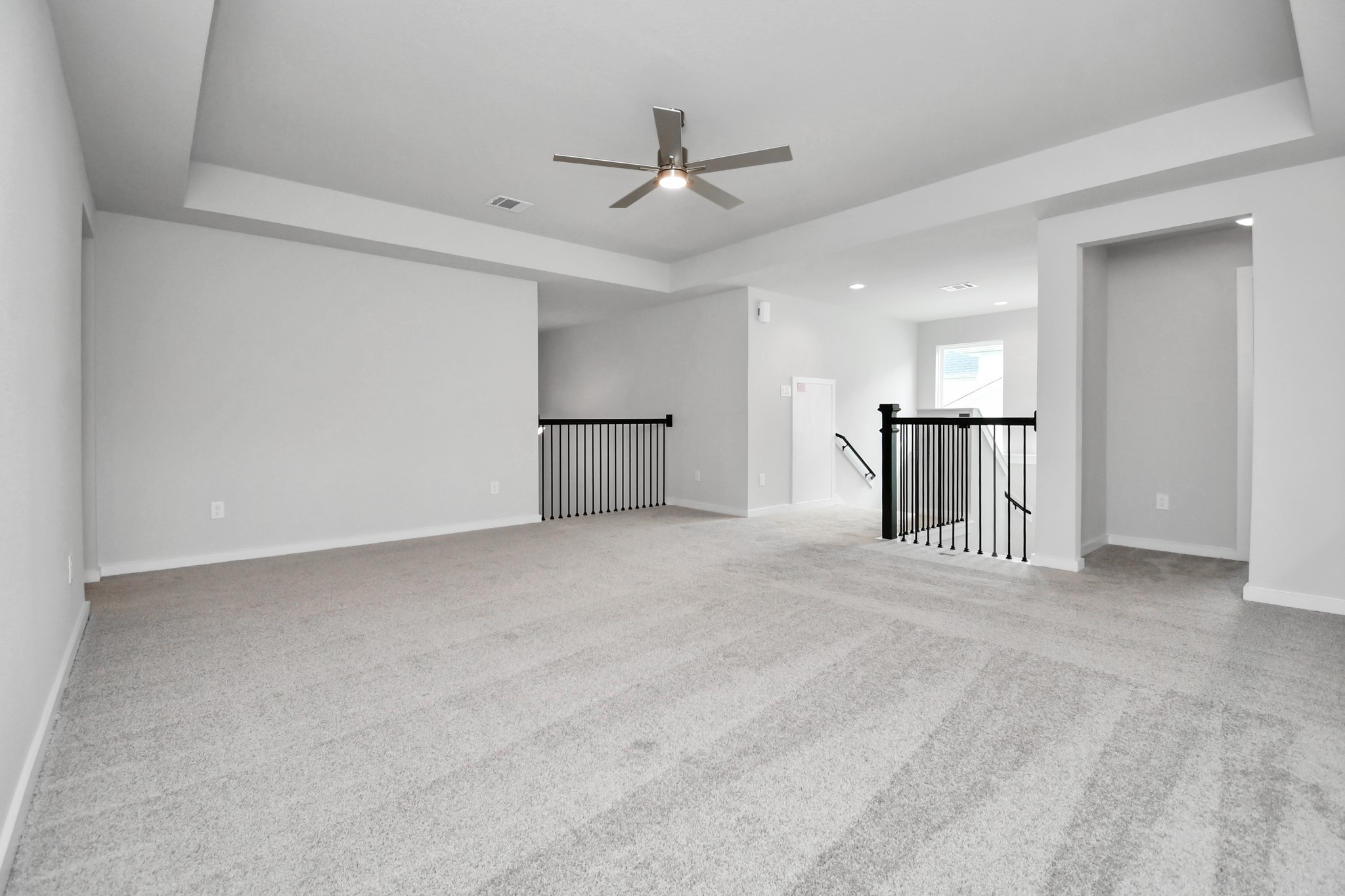 Come upstairs and enjoy a day of leisure in this fabulous game room! This is the perfect hangout spot or adult game room! Features plush carpet, high ceilings, custom paint and windows for plenty of natural light. Sample photo of completed home with similar floor plan. Actual colors and selections may vary.