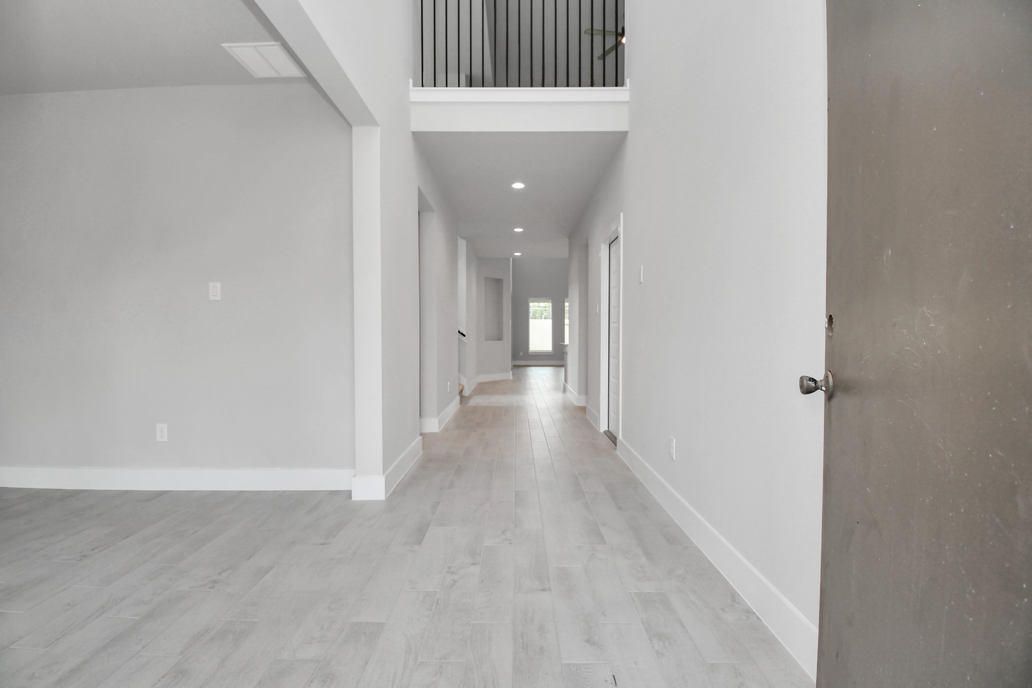 As you step into the threshold of this luxurious home, you'll soon be welcomed by an elegant glass door (to be installed). Inside, soaring ceilings amplify the spaciousness, while the refined wood-look tile flooring and oversized baseboards exude sophistication and charm. Sample photo of completed home with similar floor plan. Actual colors and selections may vary. As you step into the threshold of this luxurious home, you'll soon be welcomed by an elegant glass door (to be installed). Inside, soaring ceilings amplify the spaciousness, while the refined wood-look tile flooring and oversized baseboards exude sophistication and charm. Sample photo of completed home with similar floor plan. Actual colors and selections may vary.