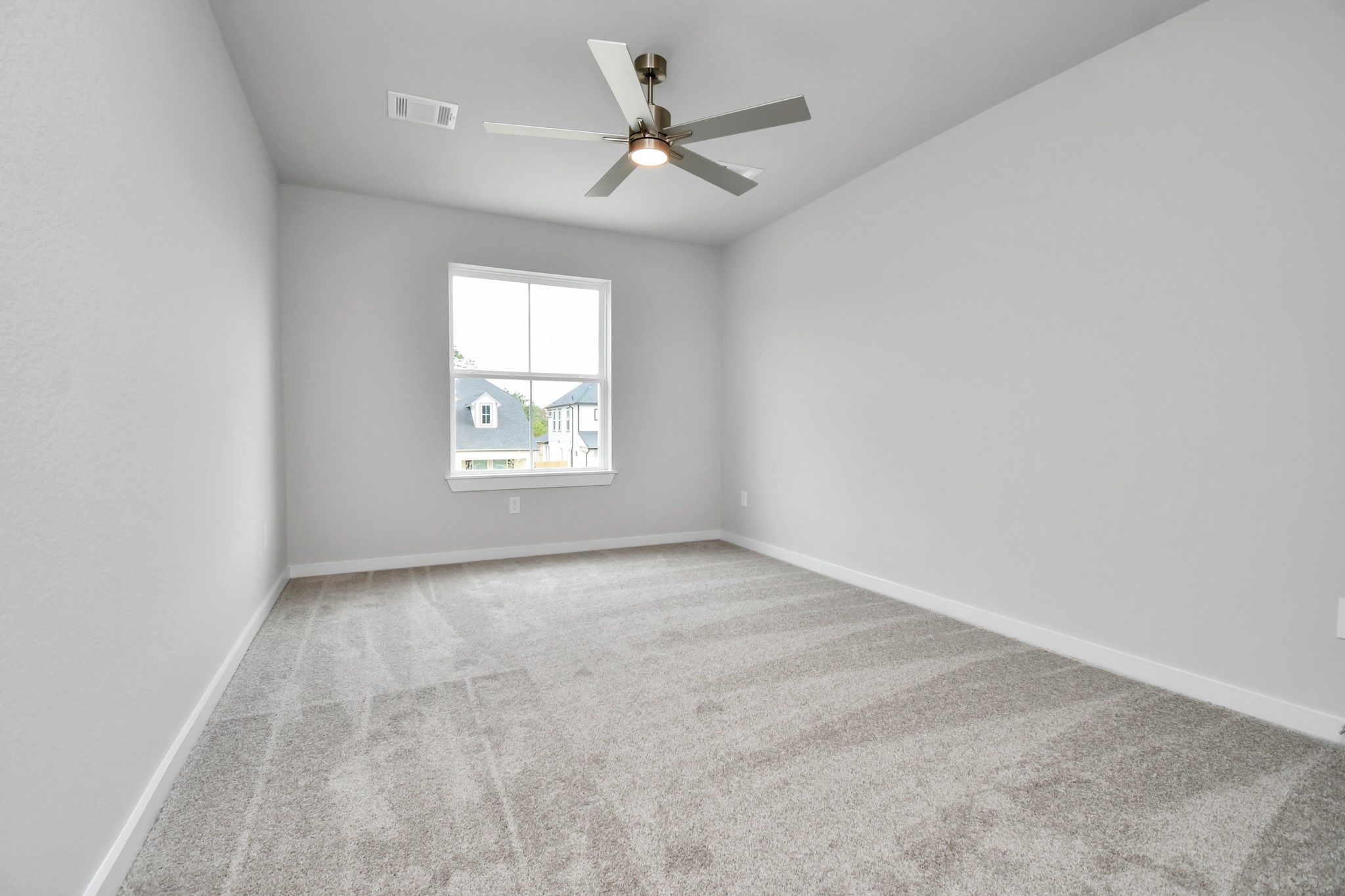 Secondary bedroom features plush carpeting, large windows that let in plenty of natural light, bright paint, and spacious closets. Sample photo of completed home with similar floor plan. Actual colors and selections may vary.