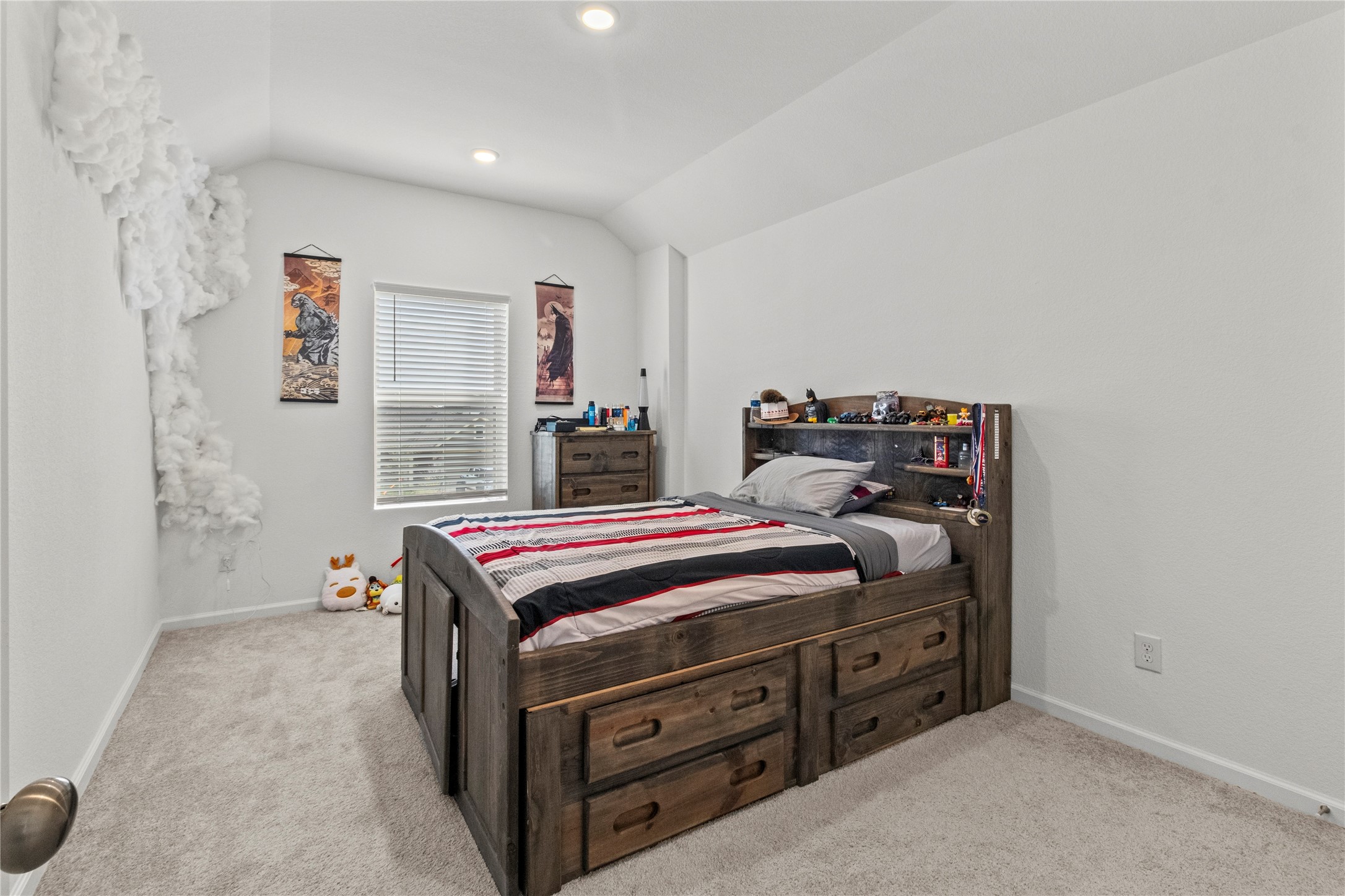 Cozy bedroom with carpet flooring, and bright natural light from a central window.