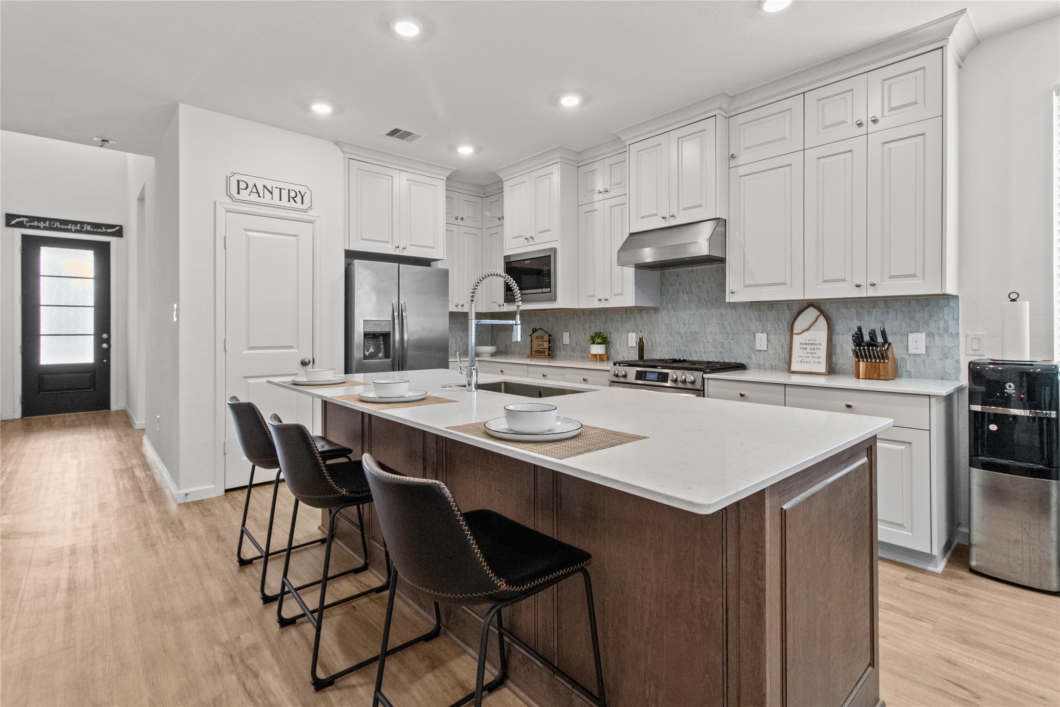 Elegant kitchen with a spacious island, sleek stainless steel appliances, and abundant cabinetry.
