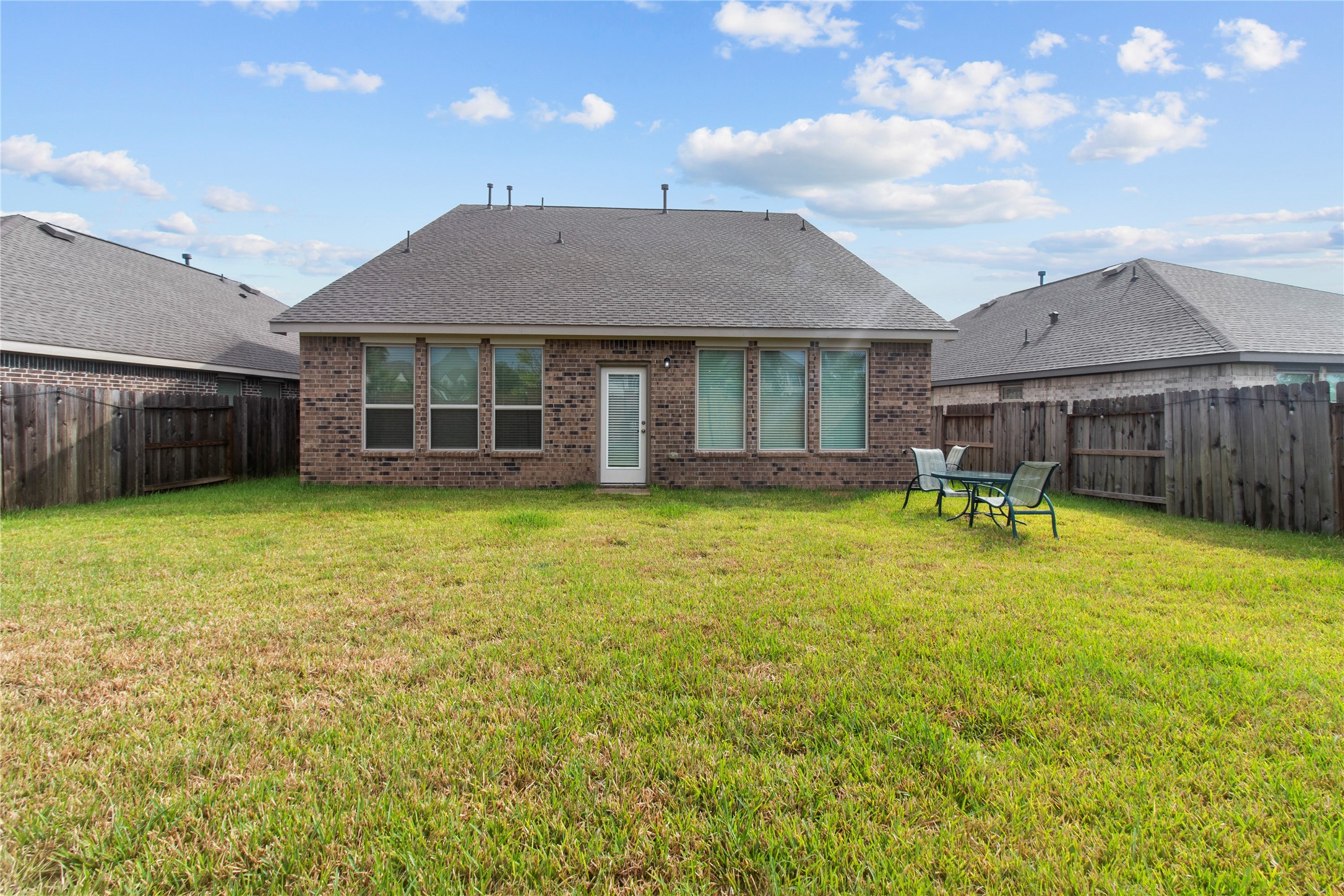 Spacious fenced backyard with a well-maintained lawn, perfect for outdoor entertaining or relaxing with family.