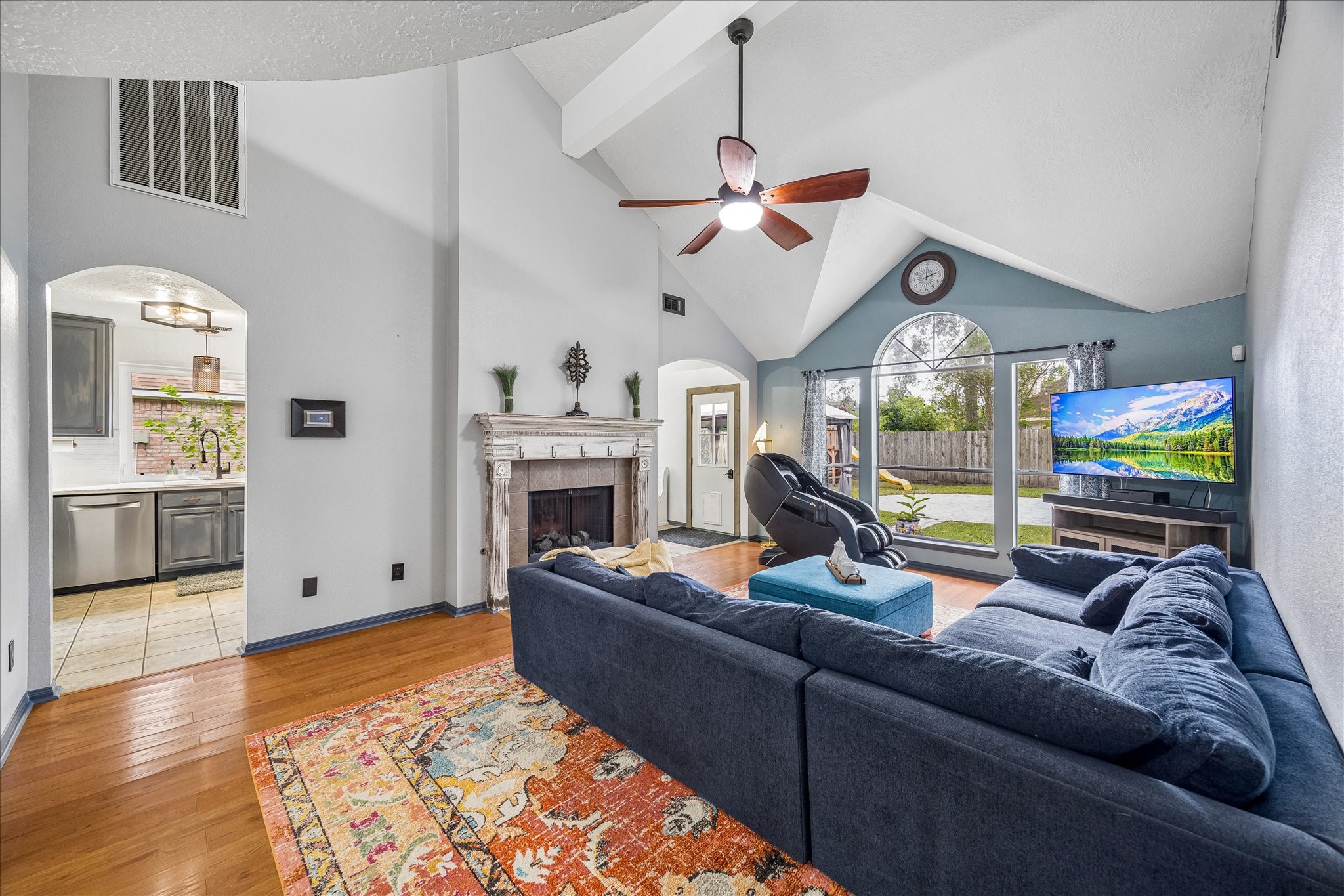 The living room, fireplace, view of backyard & easy kitchen access