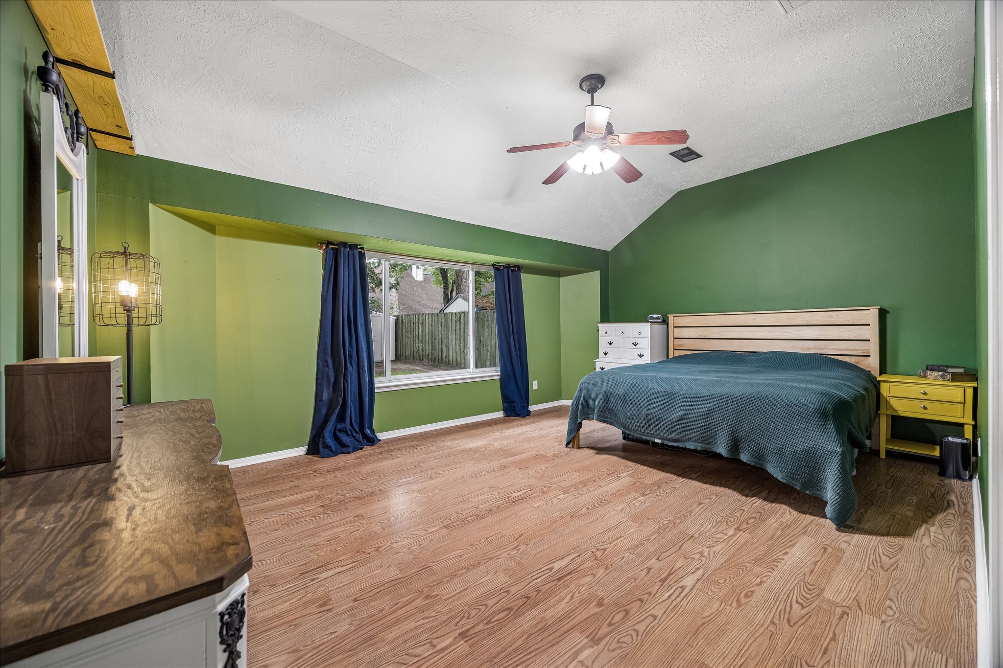 Primary bedroom has large picture window to backyard