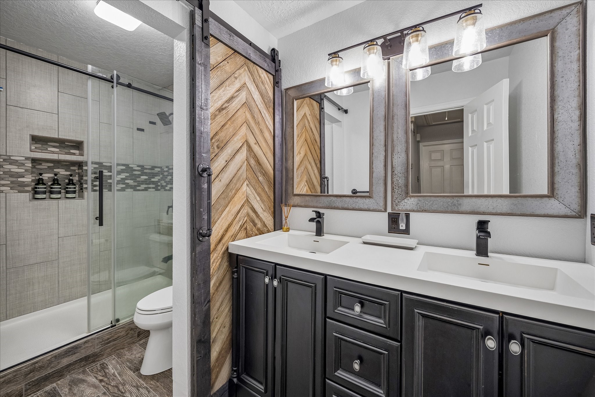 Updated guest bathroom with separate dual sink and tub/toilet area