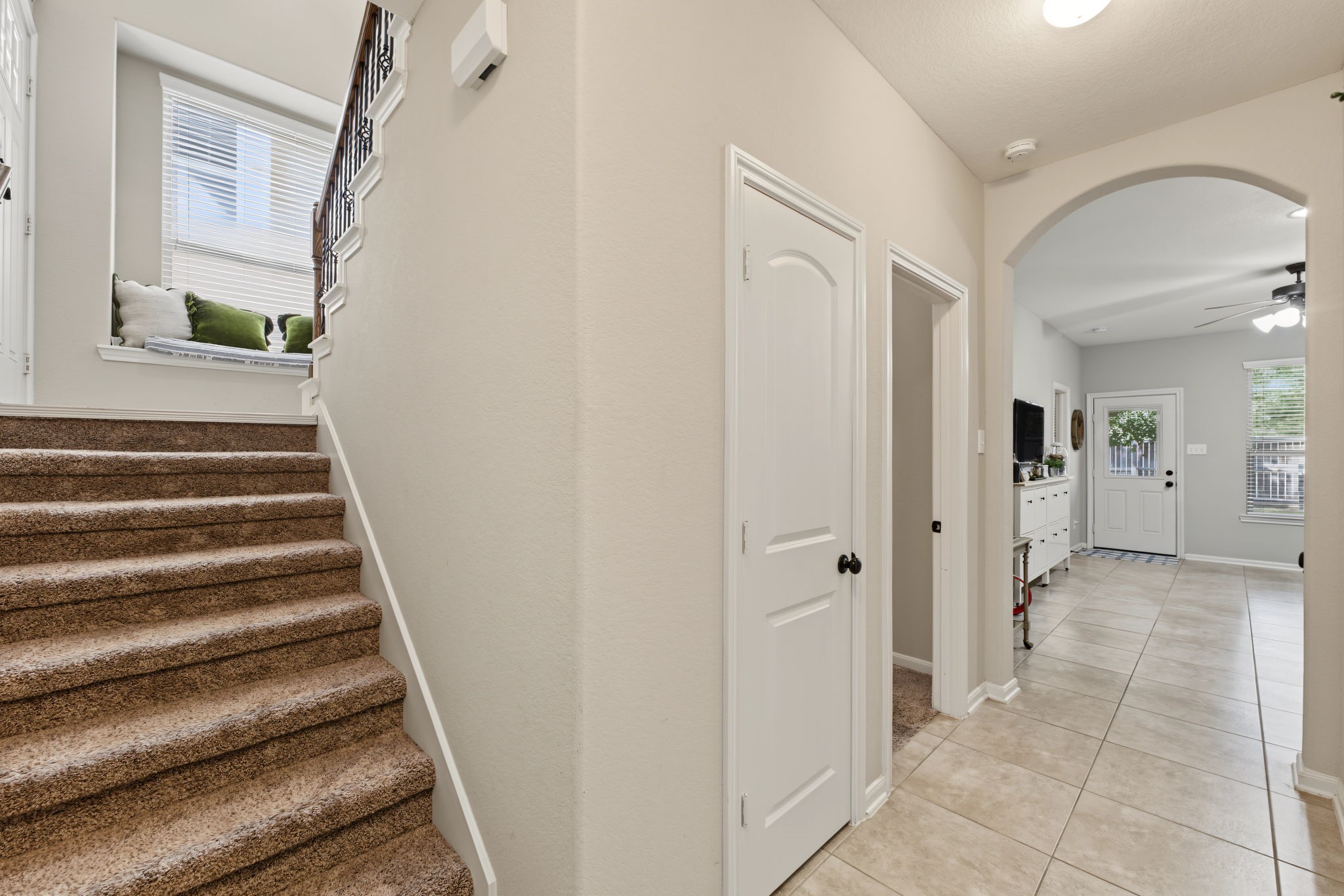 A view as you enter the home from the garage (downstairs) You can see storage closet with a hallway leading to the secondary bedrooms and flex space.