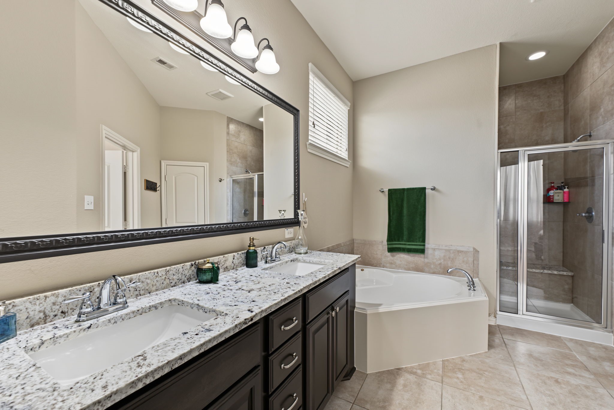 This bathroom HAS IT ALL!!  Dual sinks with ample storage, large soaking tub and an oversized shower with a bench.