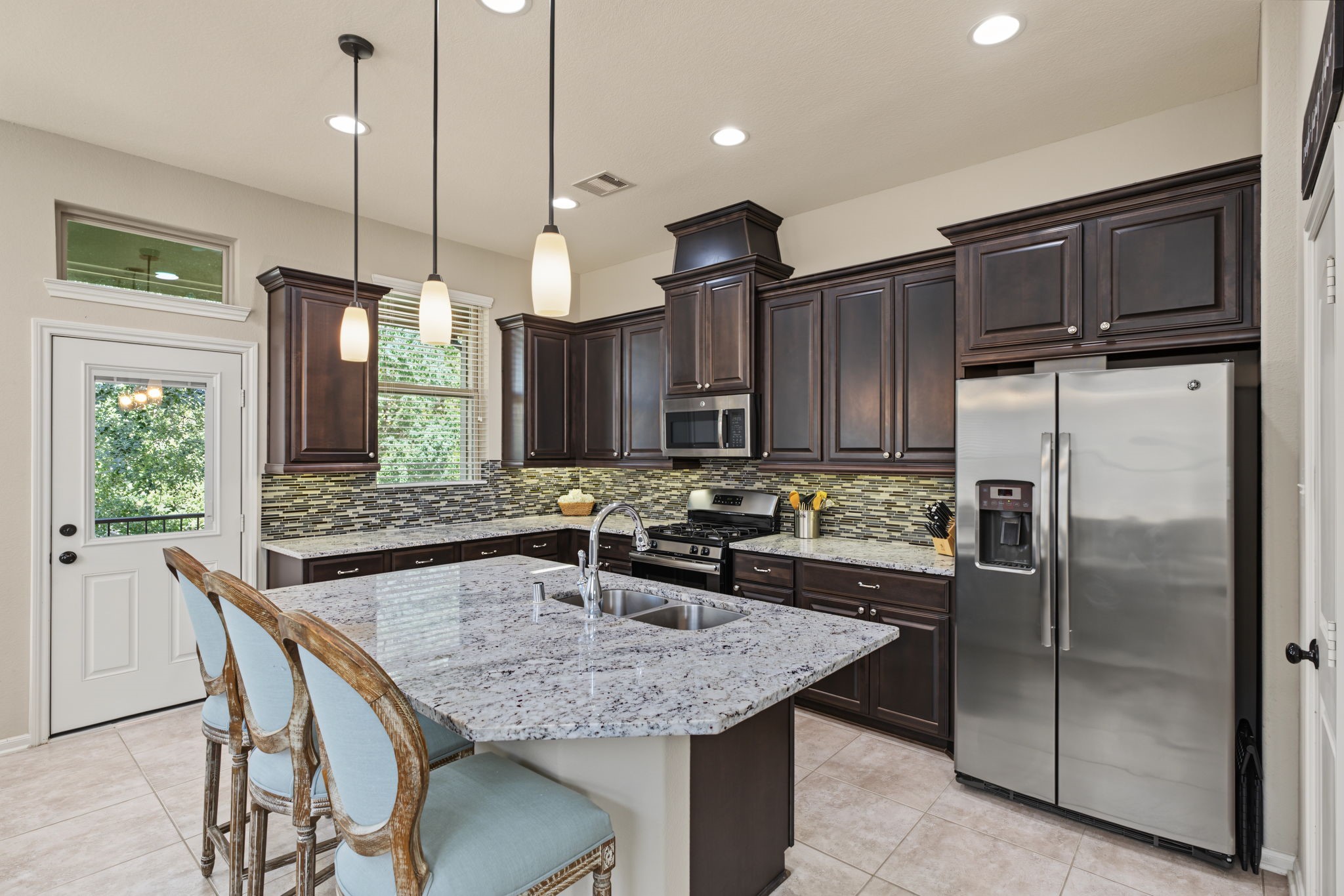 The heart of the home is calling! Enjoy a spacious kitchen with a striking island, stylish cabinetry, and room to gather around every meal.