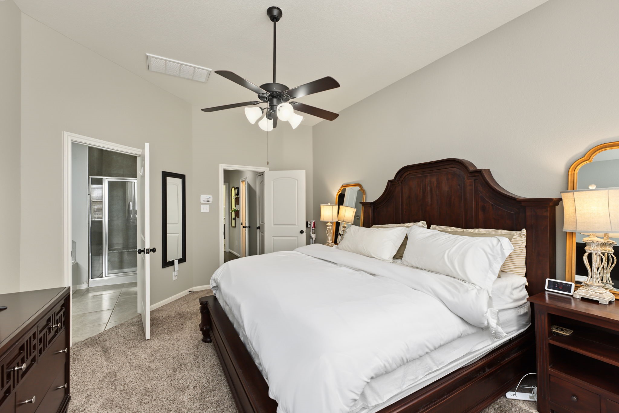 Enjoy a relaxing bedroom retreat with a comfortable layout, ceiling fan, and soft natural light for a peaceful end to your day.