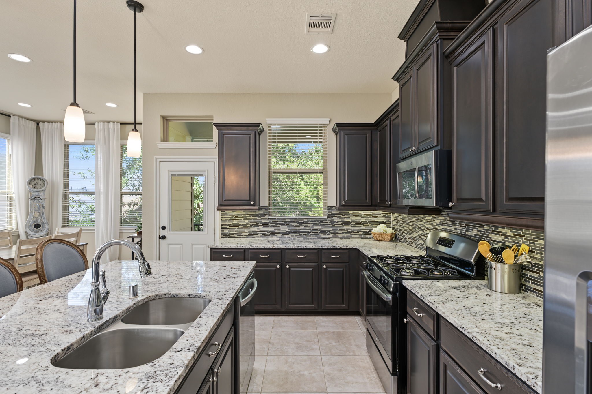 Designed to impress and built for gathering! Love the bold cabinetry, expansive island, and sophisticated style of this beautiful kitchen